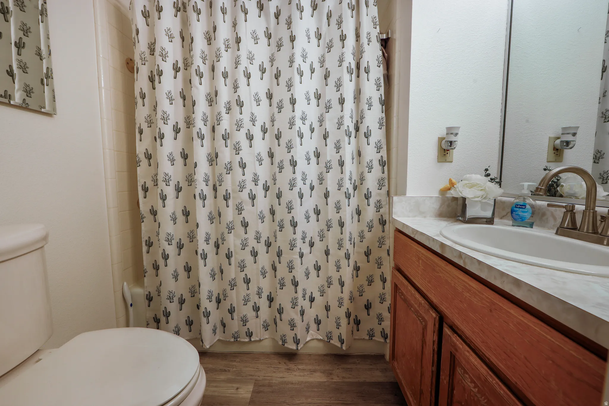 Bathroom featuring vanity and dark wood-style floors