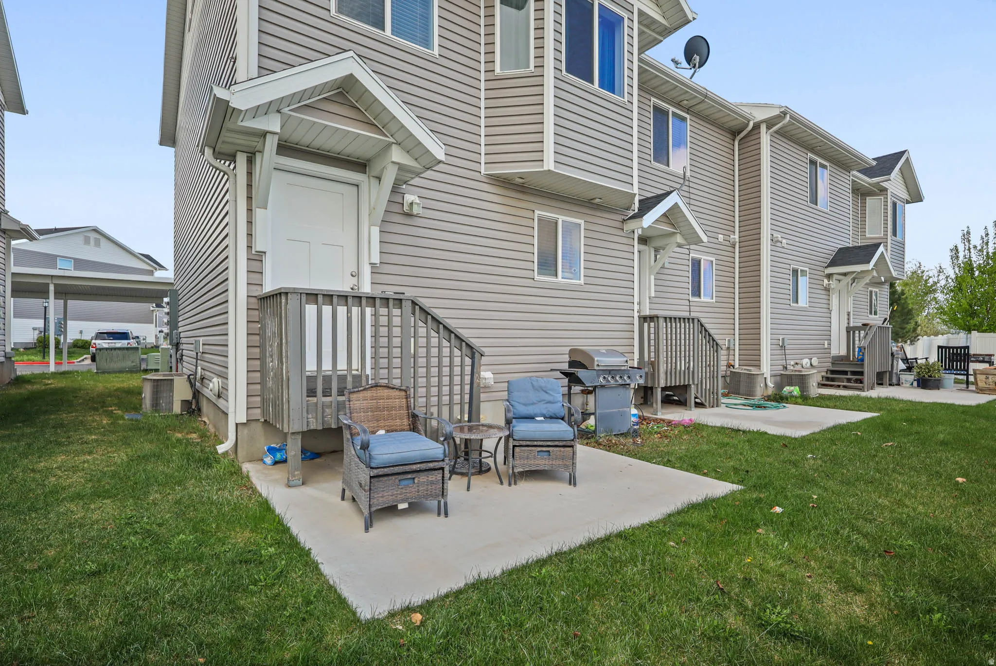 Back of property featuring a yard and a patio