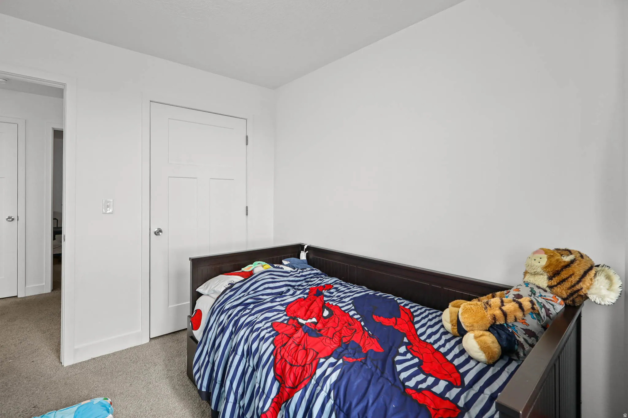 Carpeted bedroom with baseboards