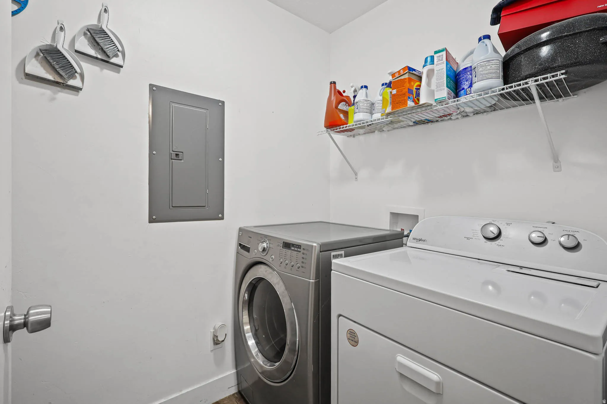 Laundry room with electric panel and washing machine and dryer