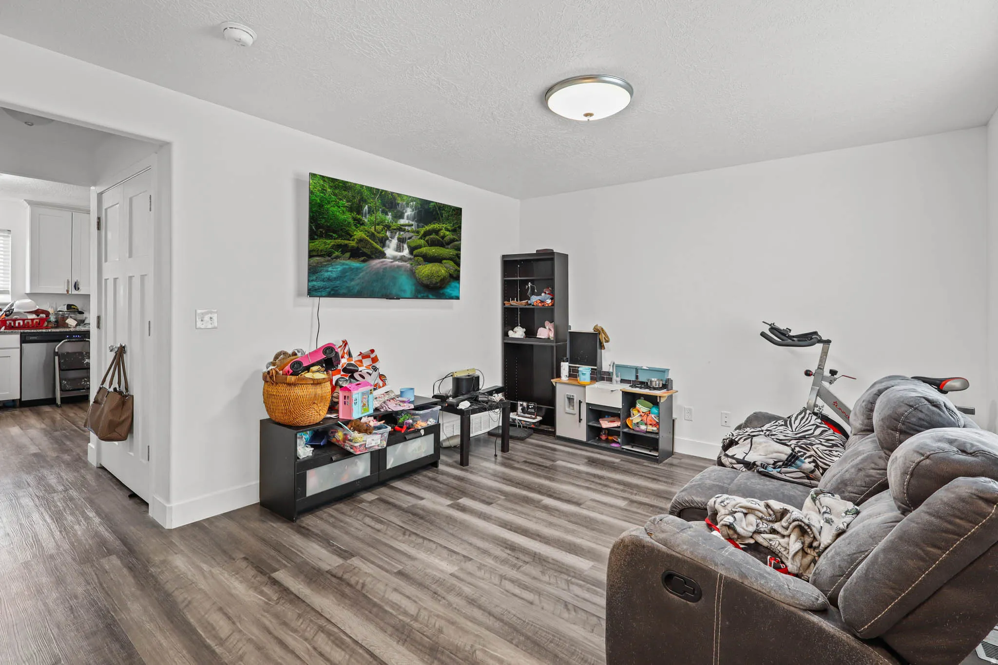 Living room featuring dark wood-style floors and a textured ceiling