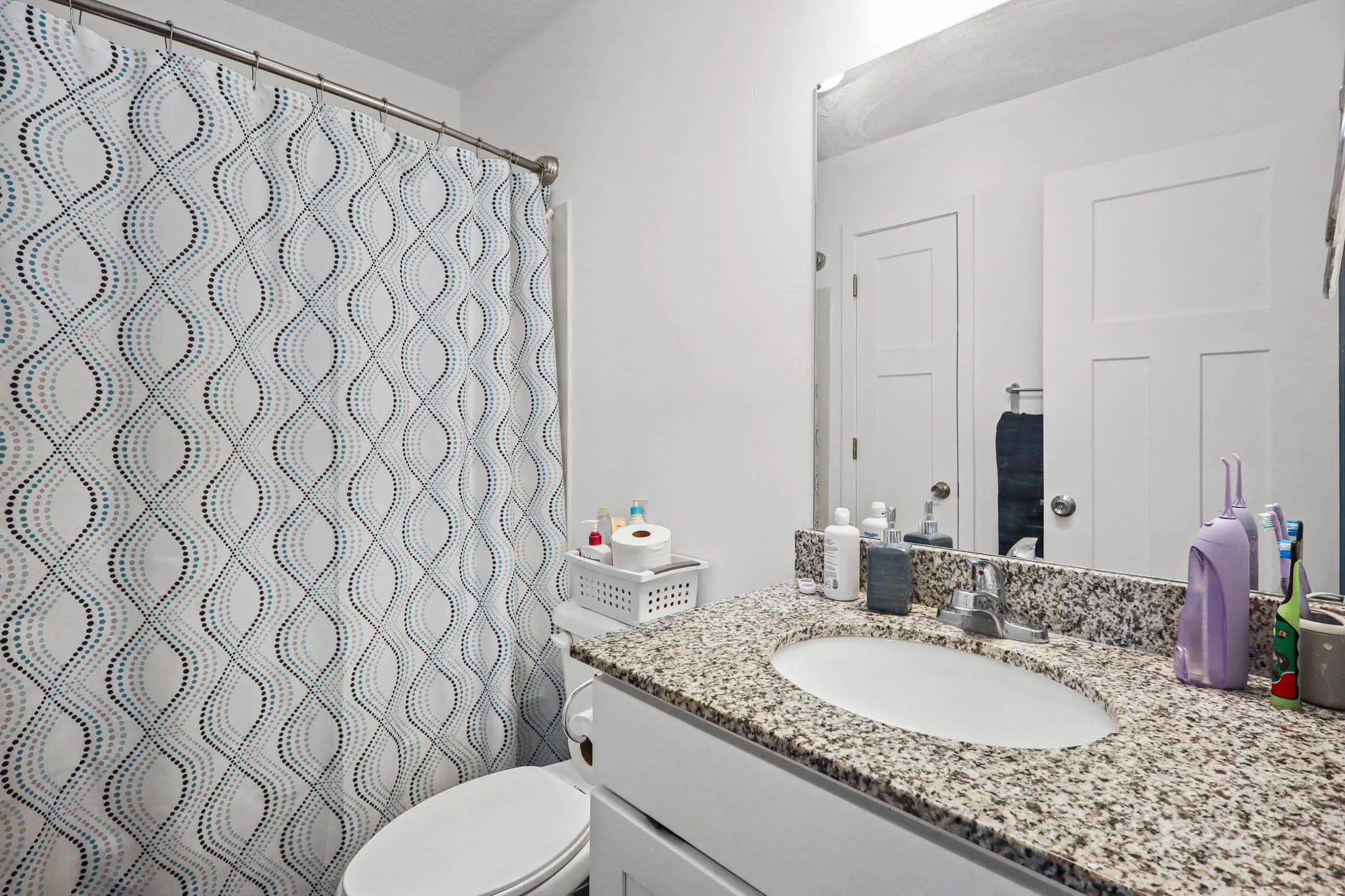 Full bath featuring vanity and a shower with shower curtain