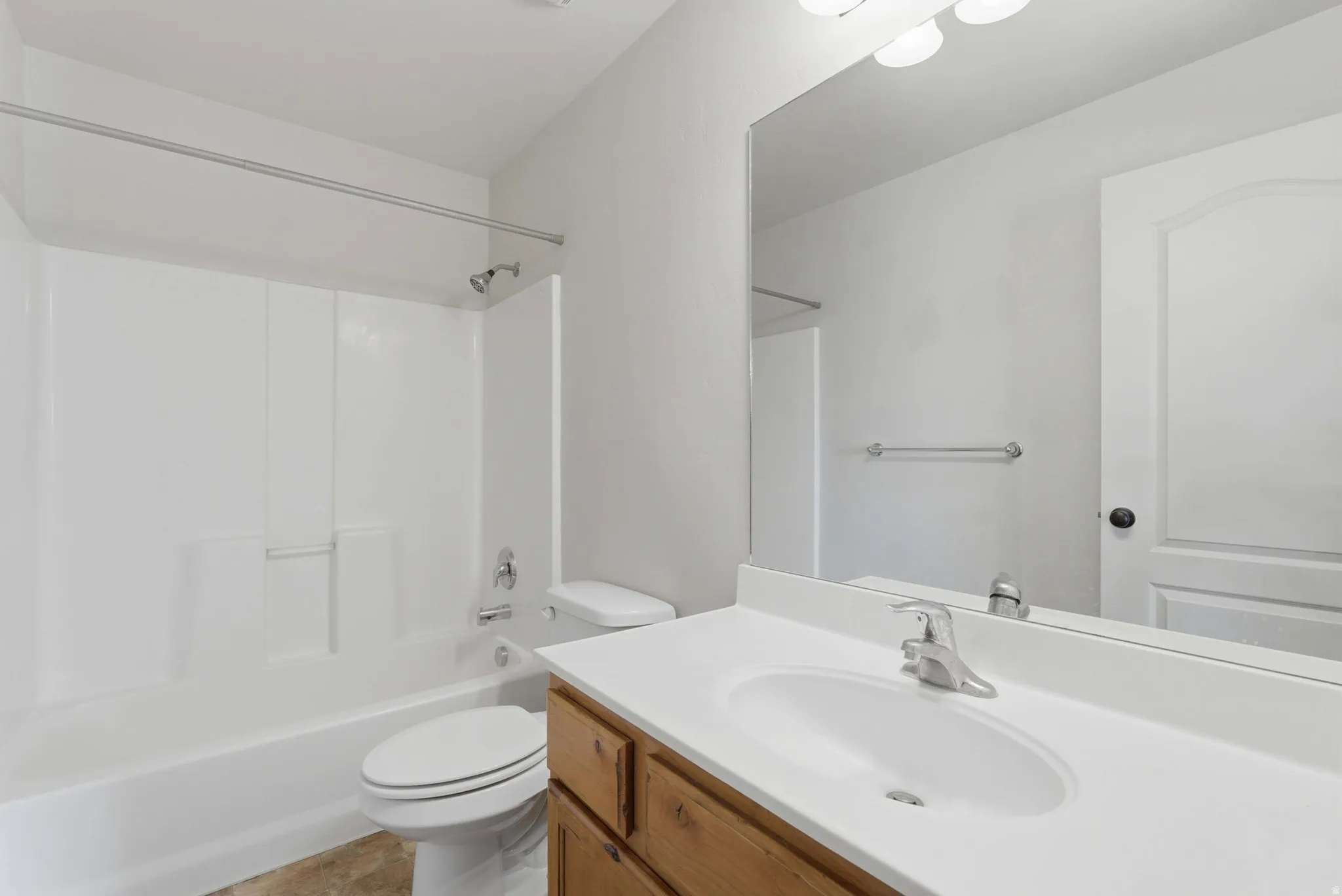 Full bath featuring vanity and shower / tub combination