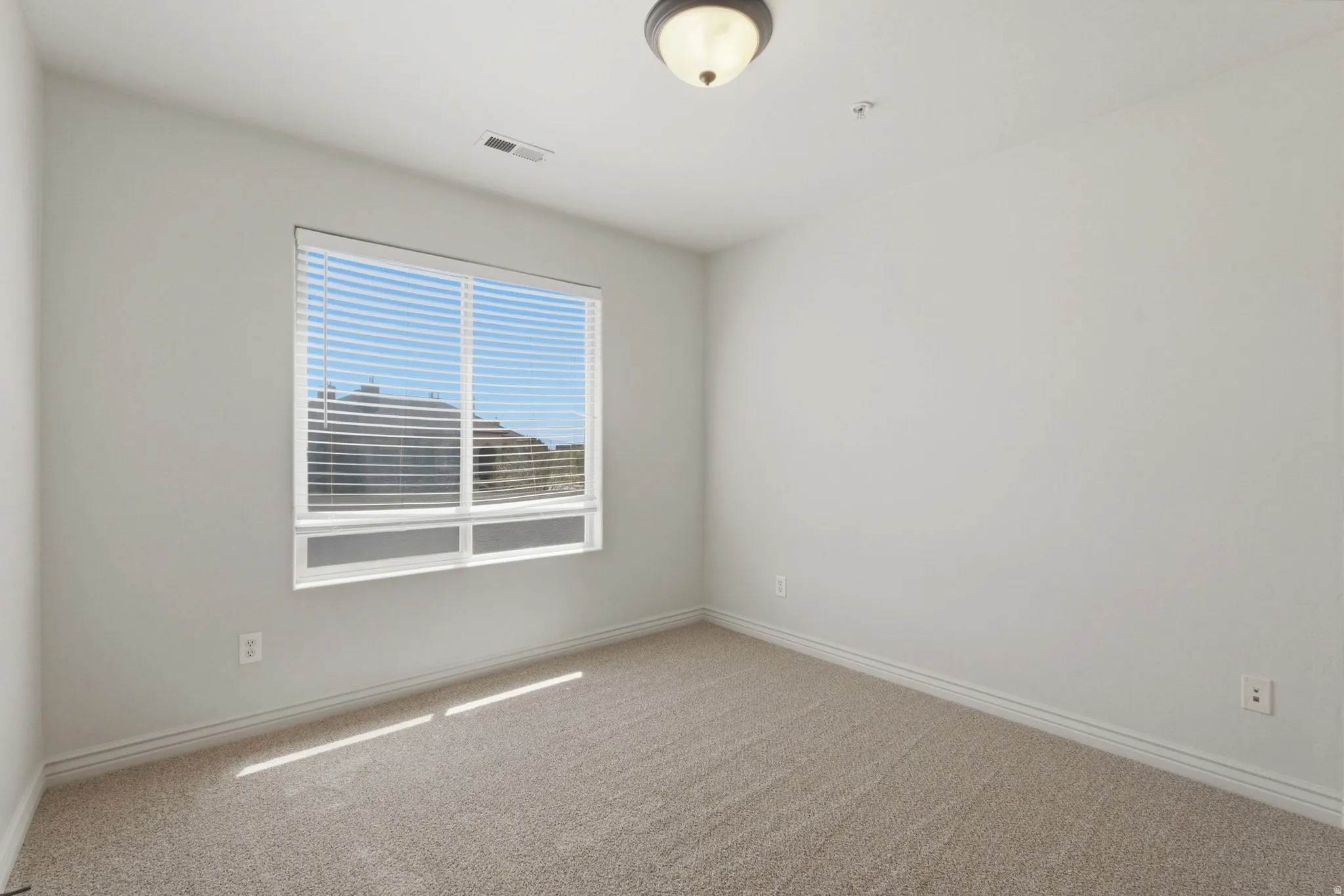 Unfurnished room with carpet and baseboards