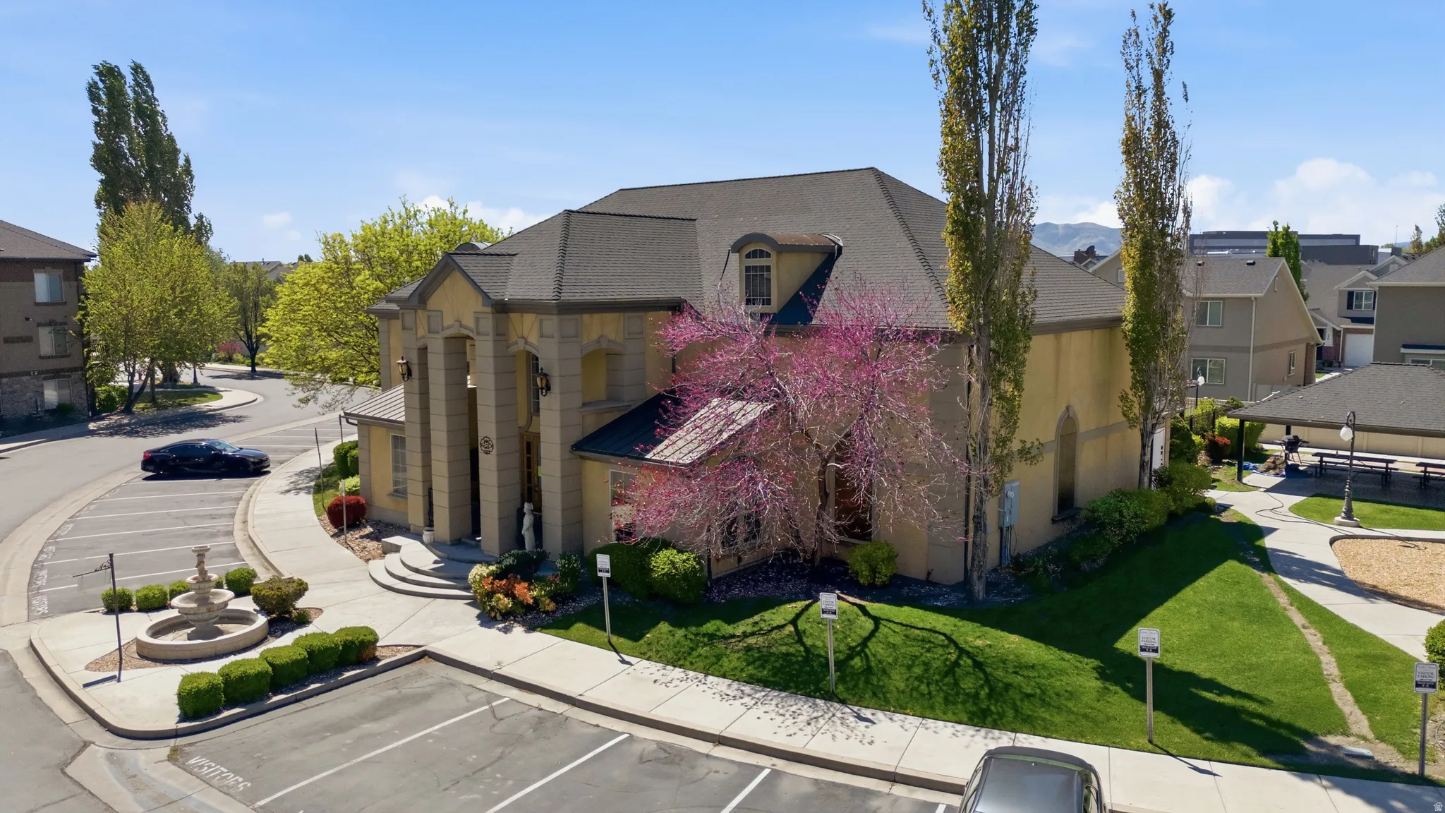 View of building exterior with a residential view and uncovered parking
