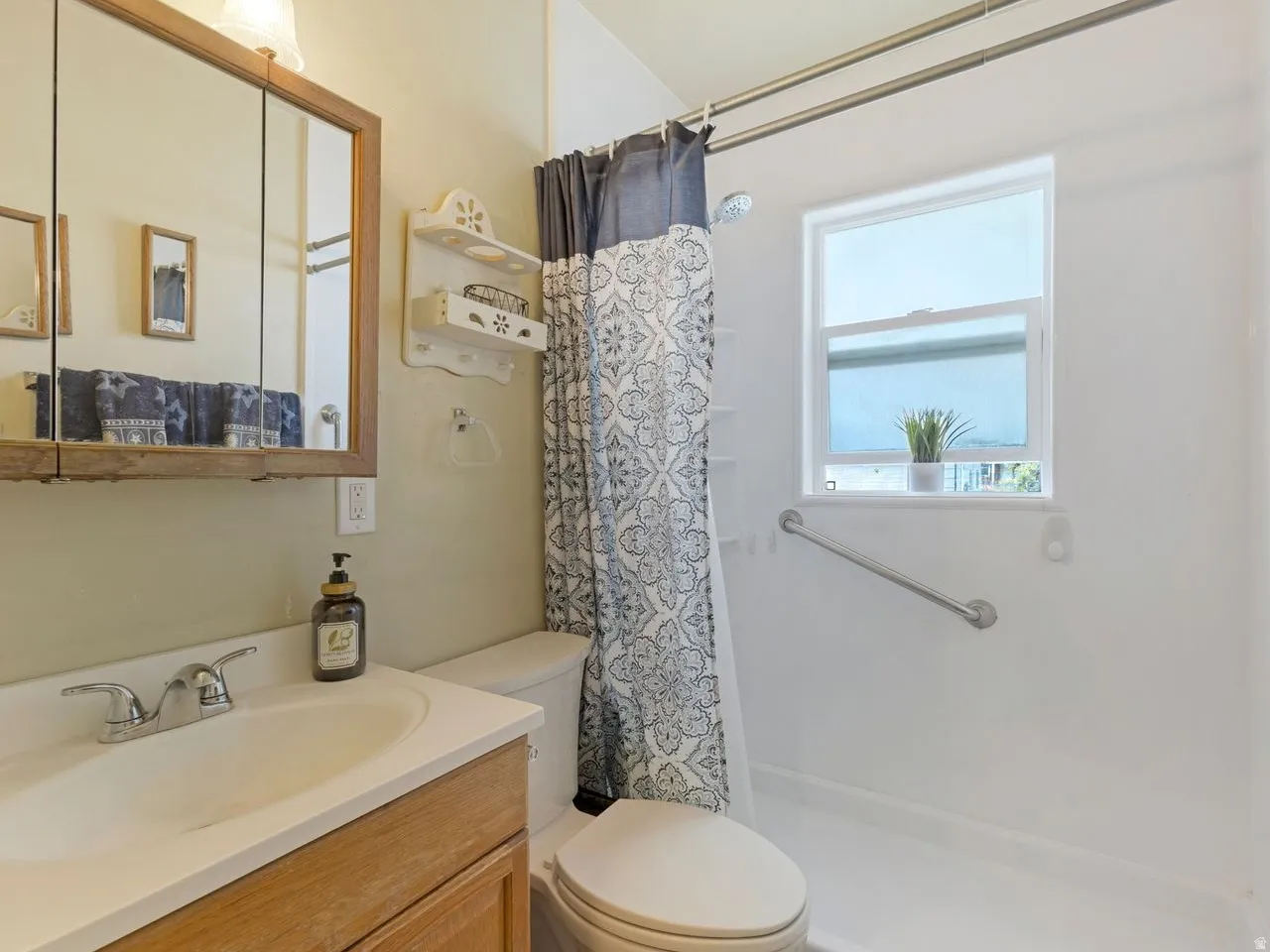 Full bath featuring vanity and a stall shower