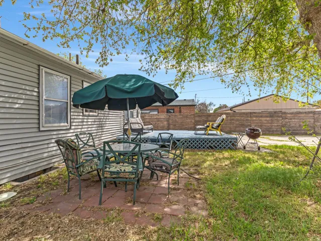 Fenced backyard with a patio area and outdoor dining area