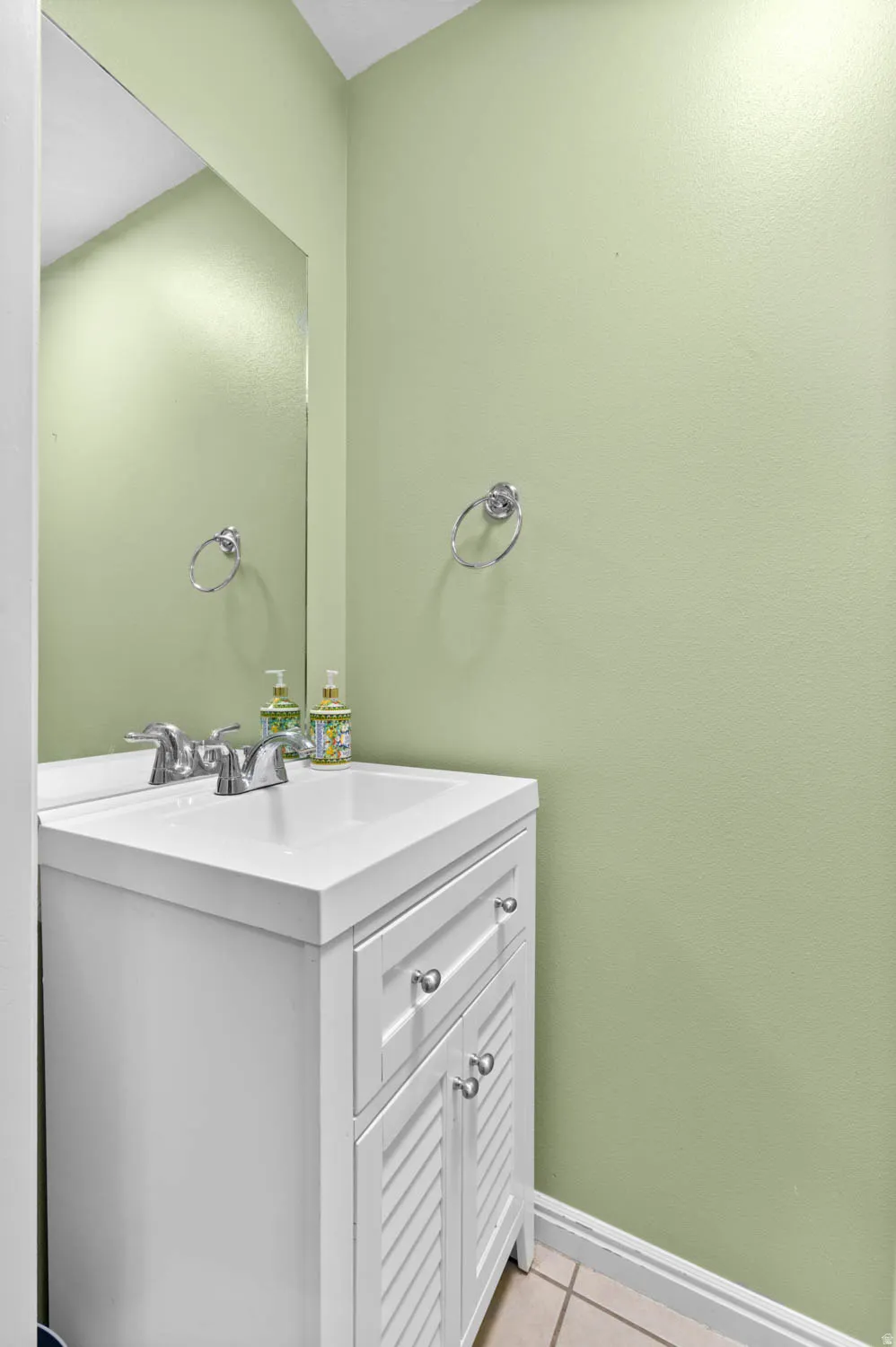 Bathroom with vanity and light tile patterned flooring