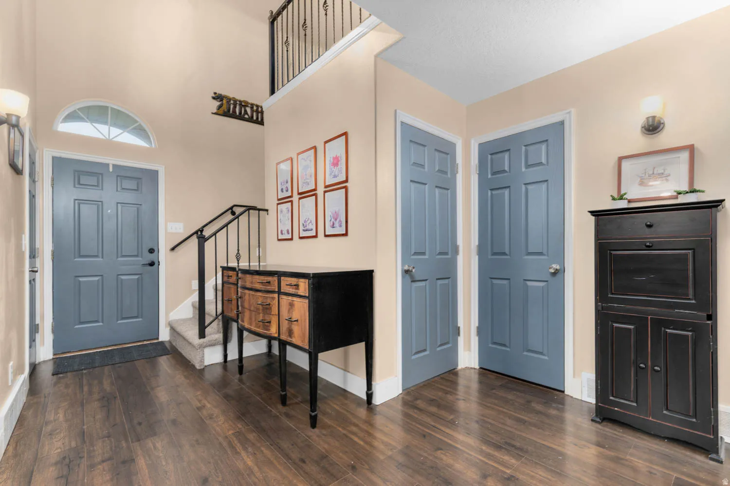 Entrance foyer with dark wood finished floors and a high ceiling