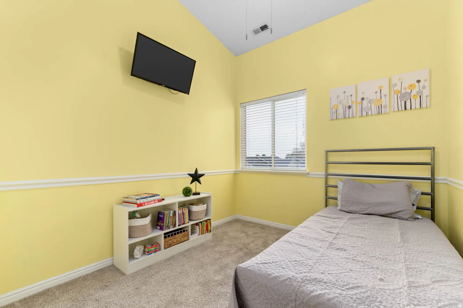 Bedroom featuring light carpet and baseboards
