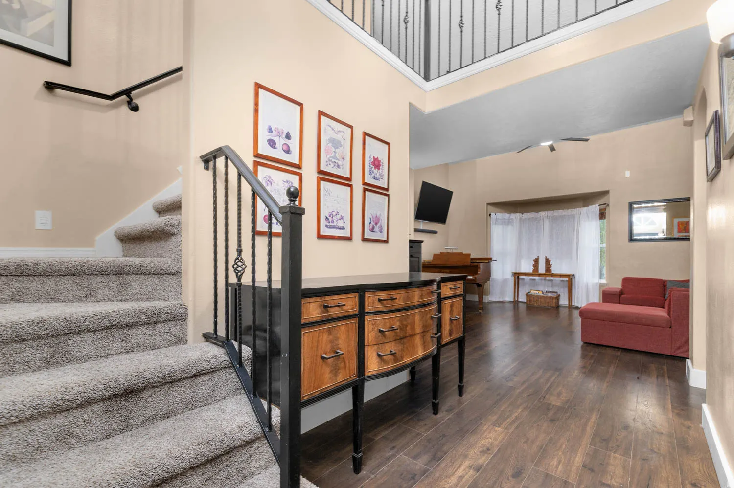Staircase with wood-type flooring and a high ceiling