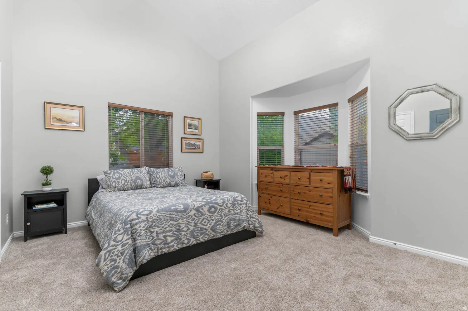 Bedroom featuring lofted ceiling and light colored carpet
