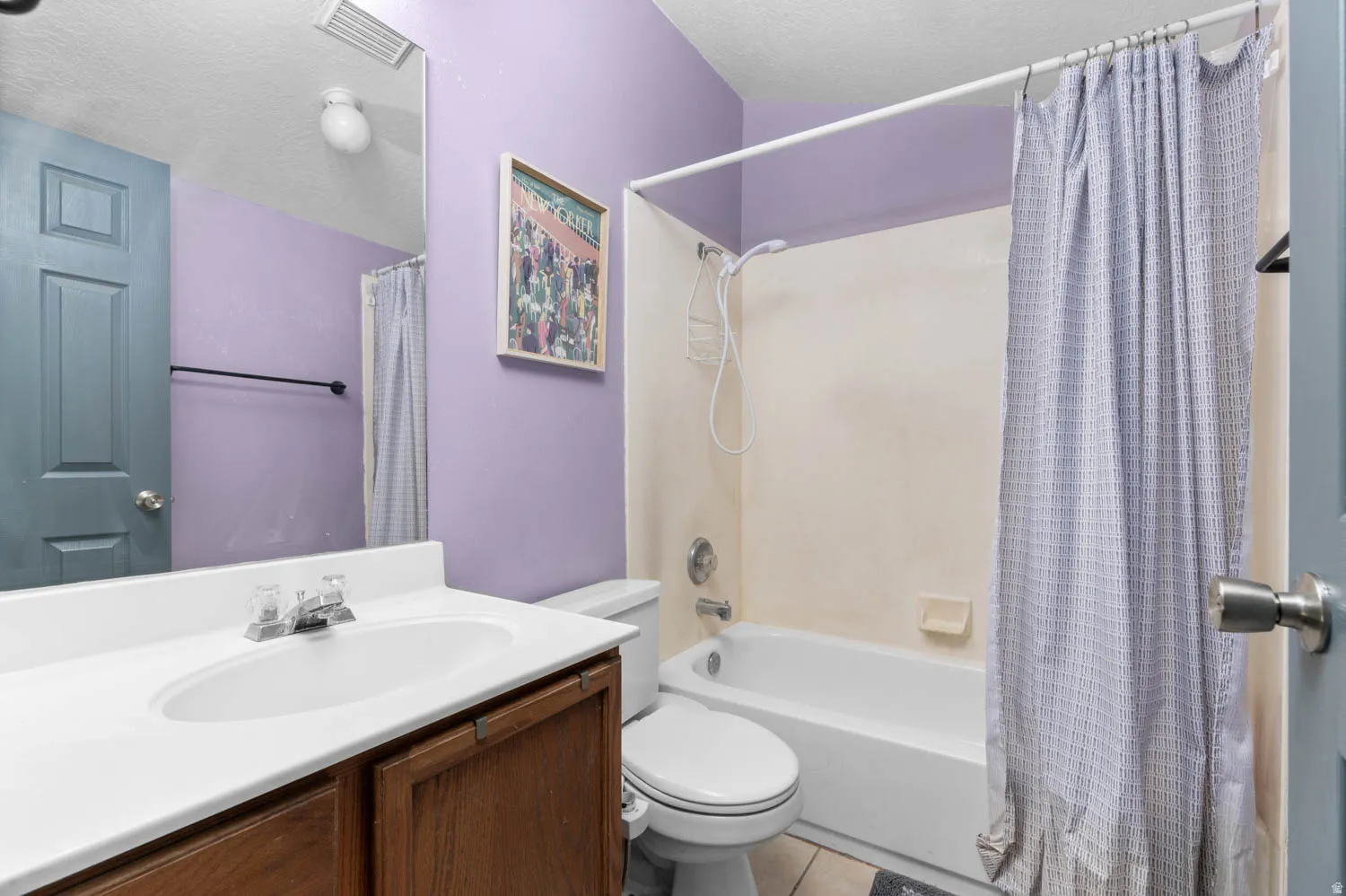 Full bath with vanity, shower / bathtub combination with curtain, and a textured ceiling