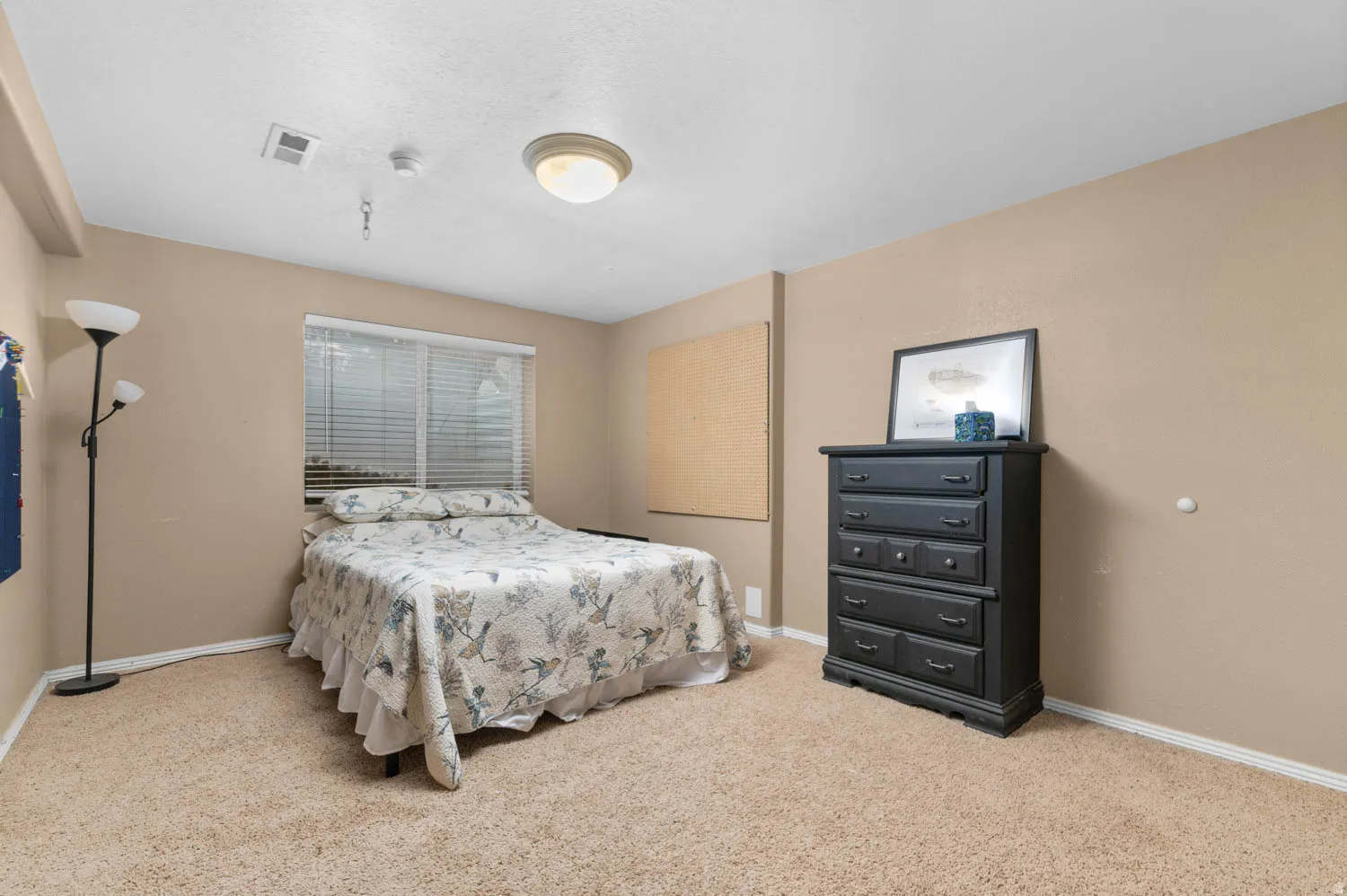 Bedroom featuring baseboards and light carpet