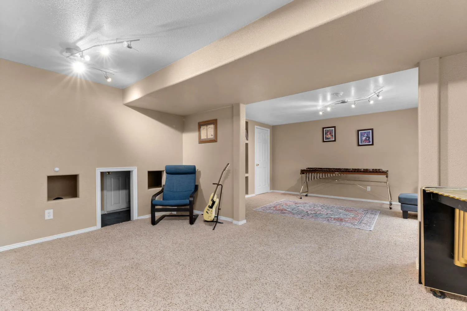 Sitting room with track lighting and light carpet