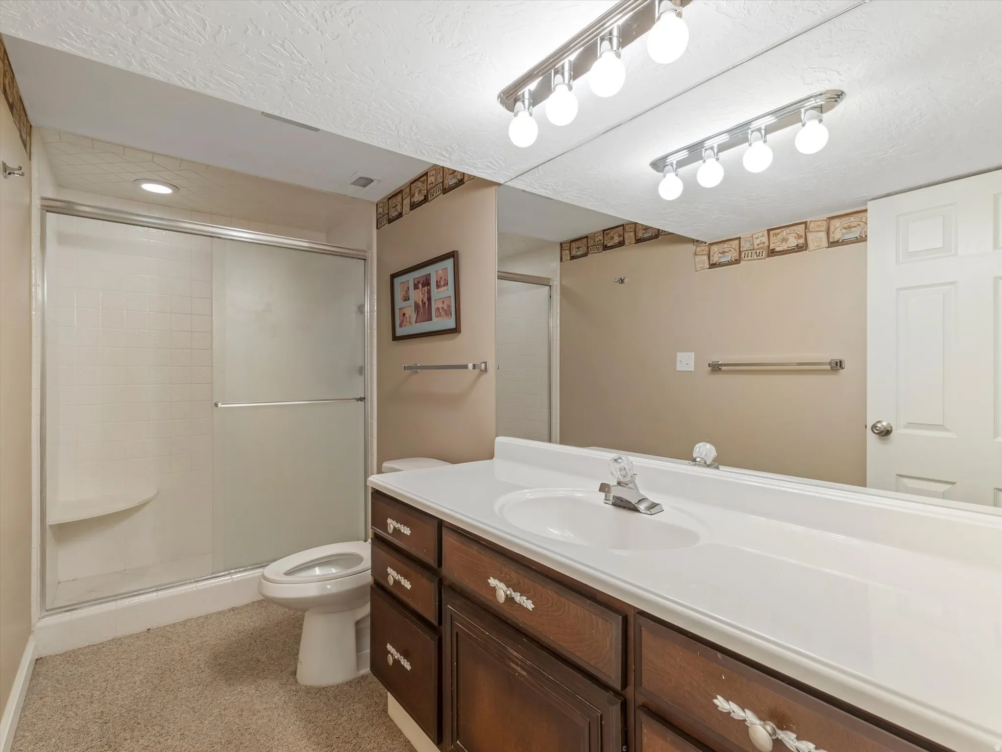 Spacious bath down with a tiled full-width shower with a built-in seat