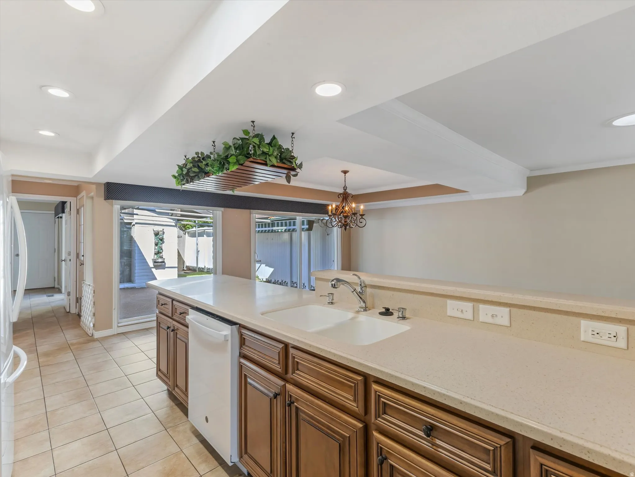 Kitchen with Corian countertops, integrated sink, and quality wood cabinetry