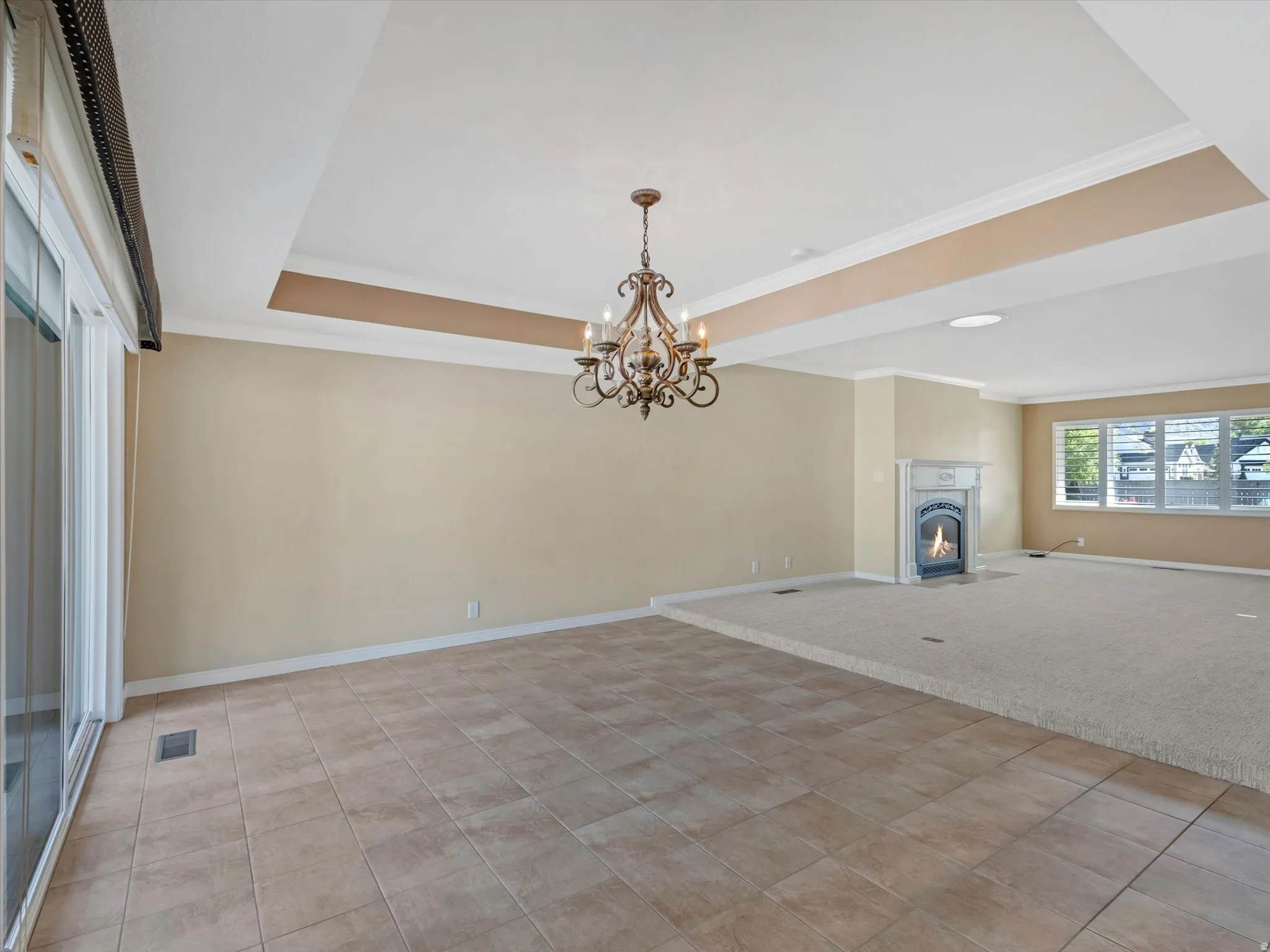 Spacious dining area with tile floor and tray ceiling