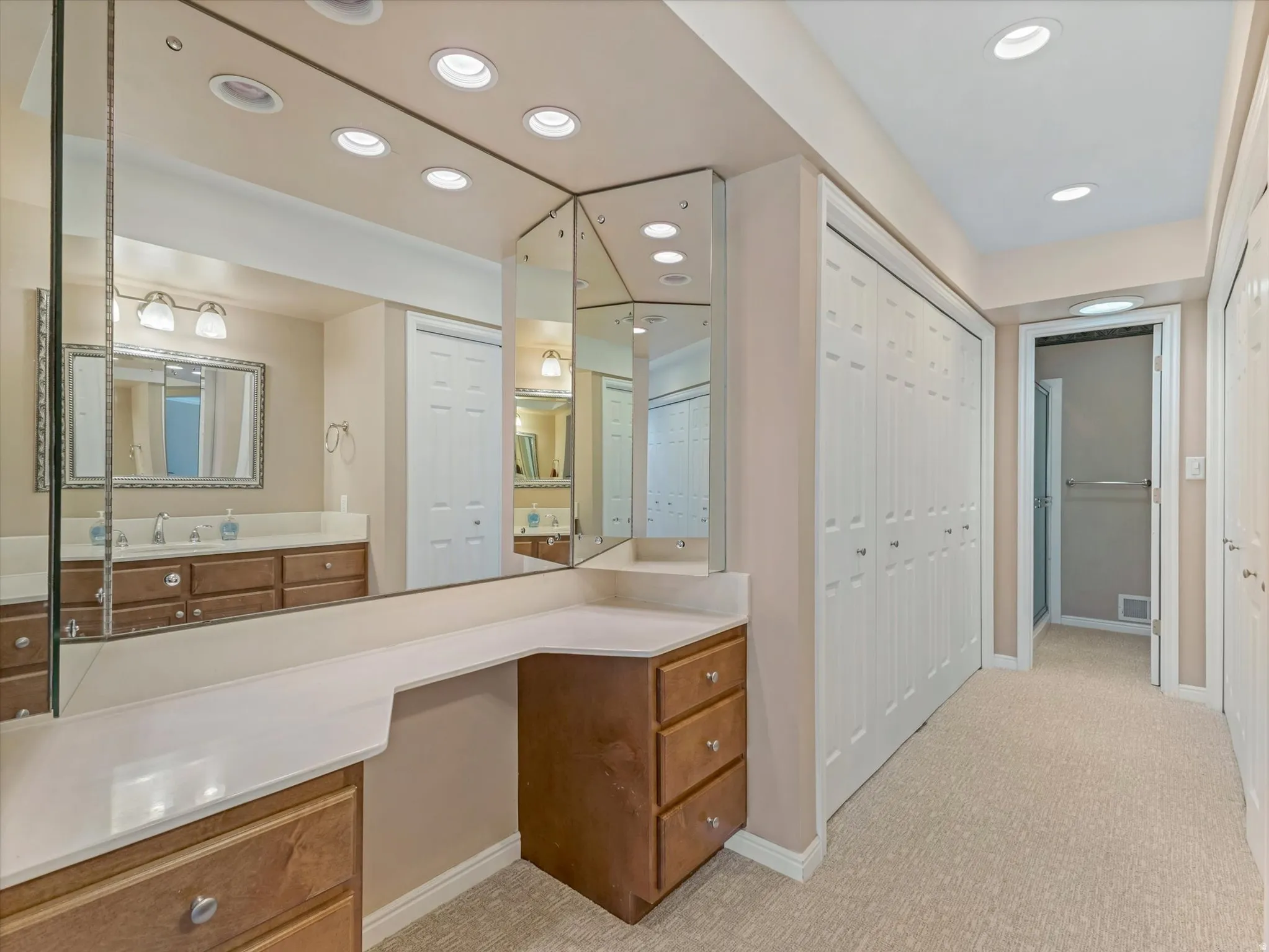 Primary bathroom with wide closets on both sides of the space