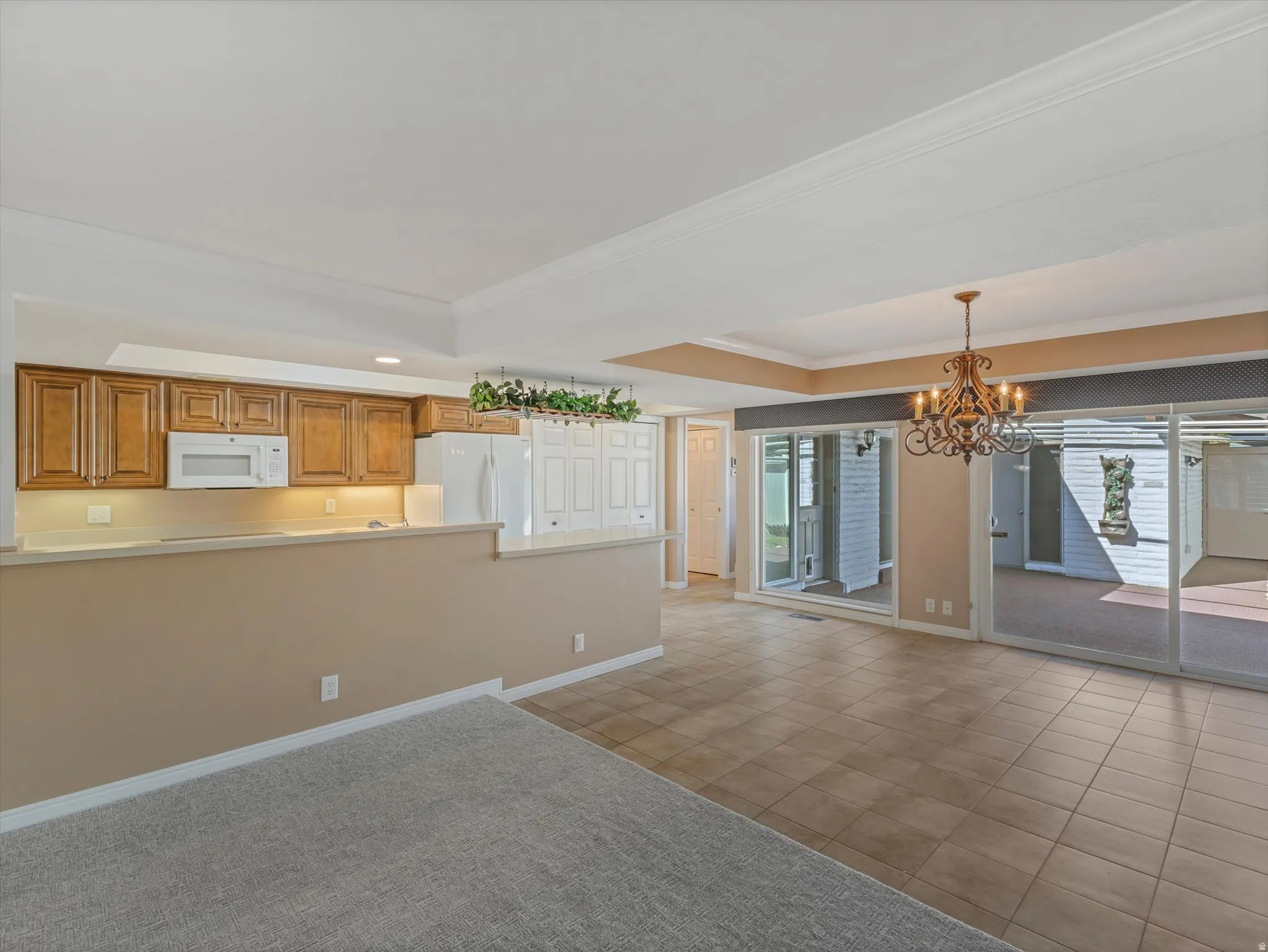 Open kitchen area, one step down to dining area, big sliding doors out to patio