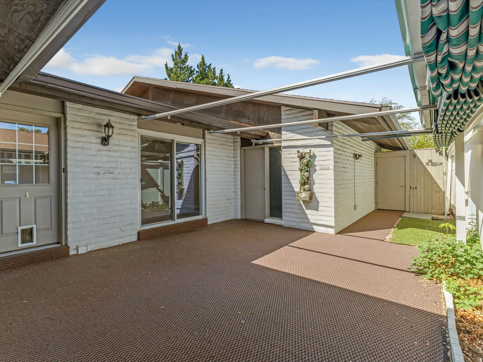 Back Patio with new awnings, plenty of room for flowers or a tomato garden!
