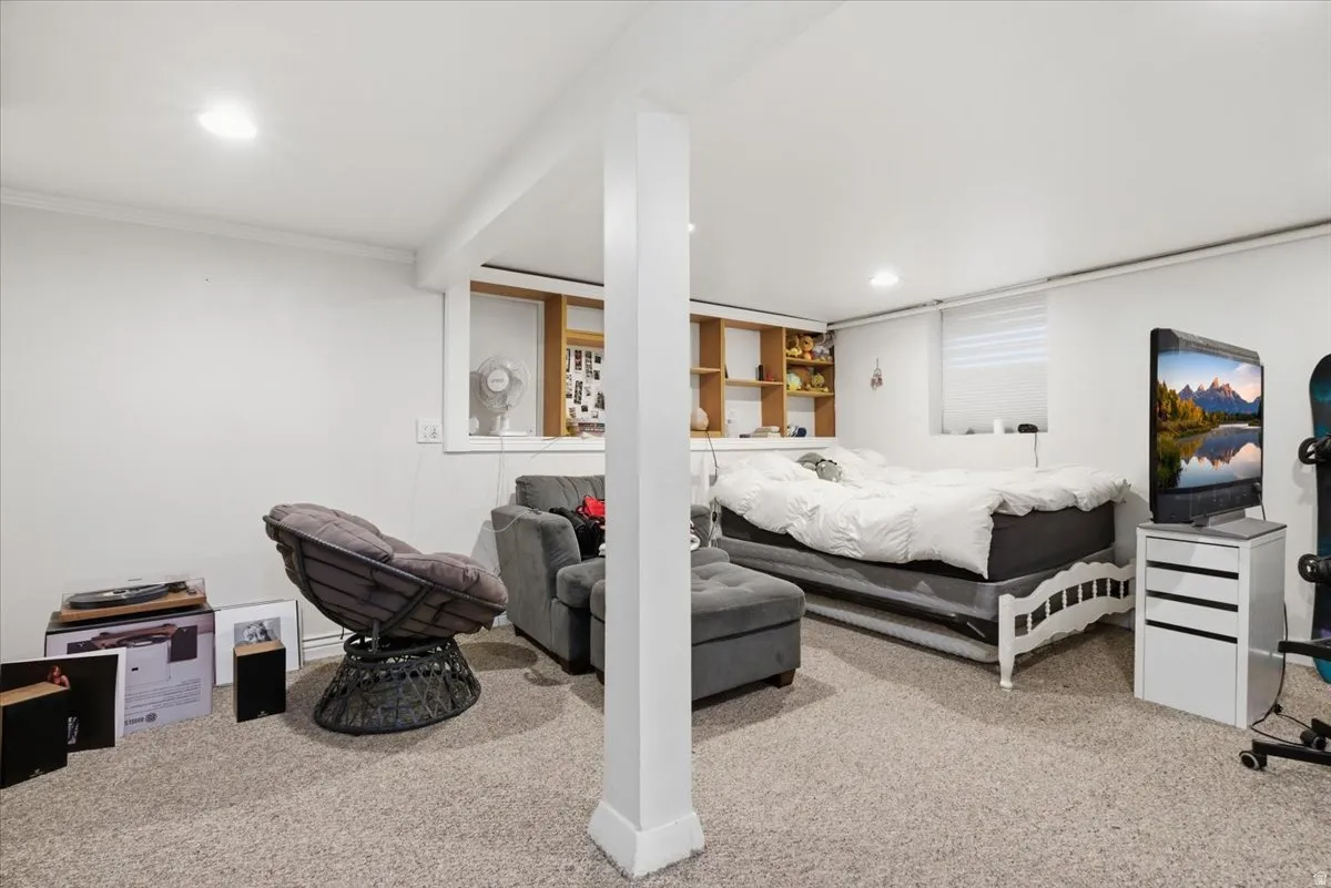 Carpeted bedroom featuring recessed lighting and crown molding