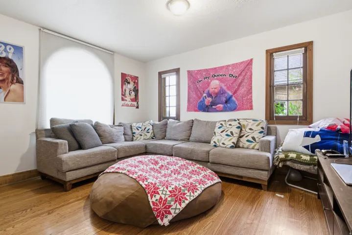 Living room featuring hardwood / wood-style floors and baseboards