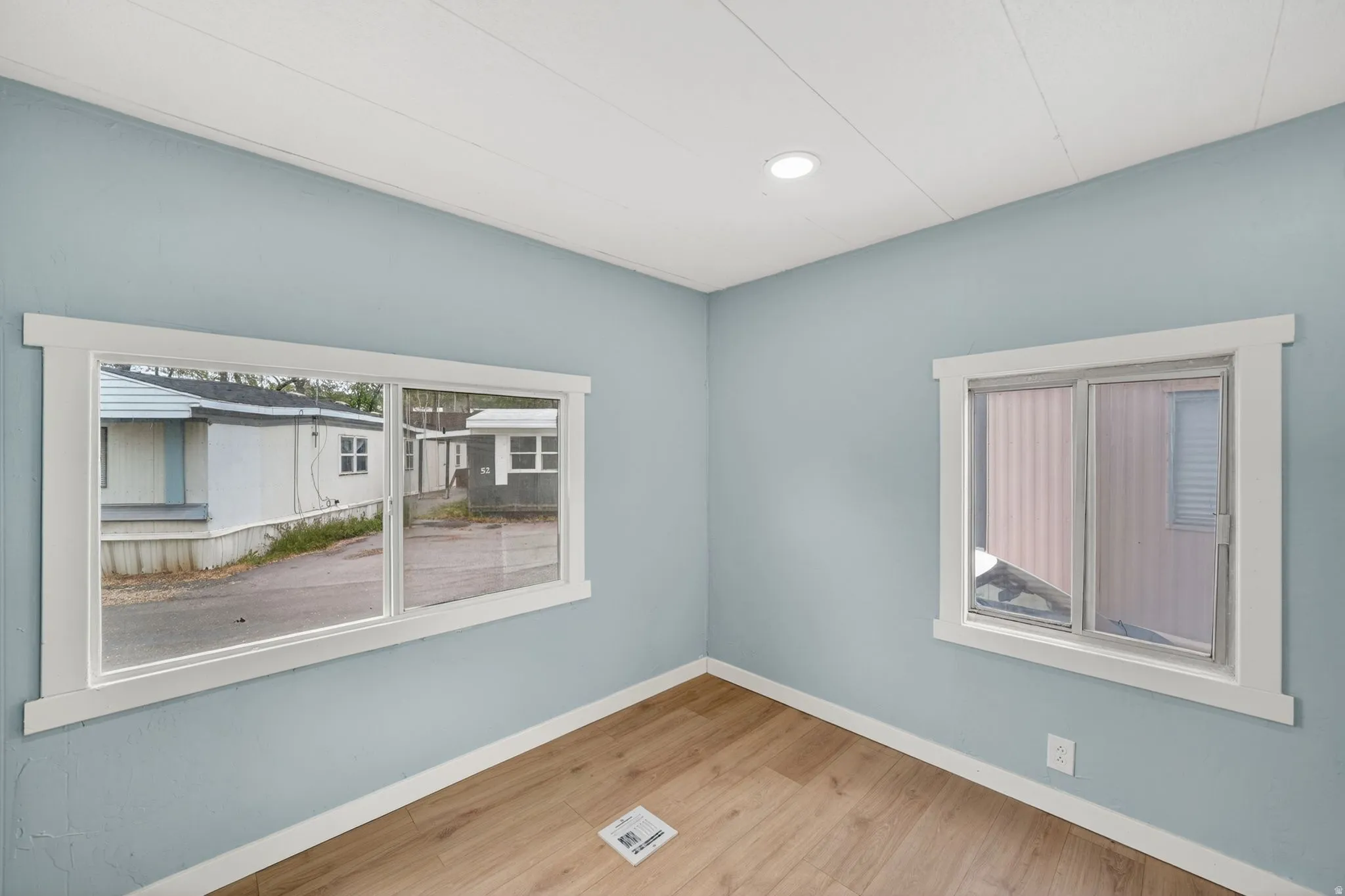 Empty room with light wood-style flooring