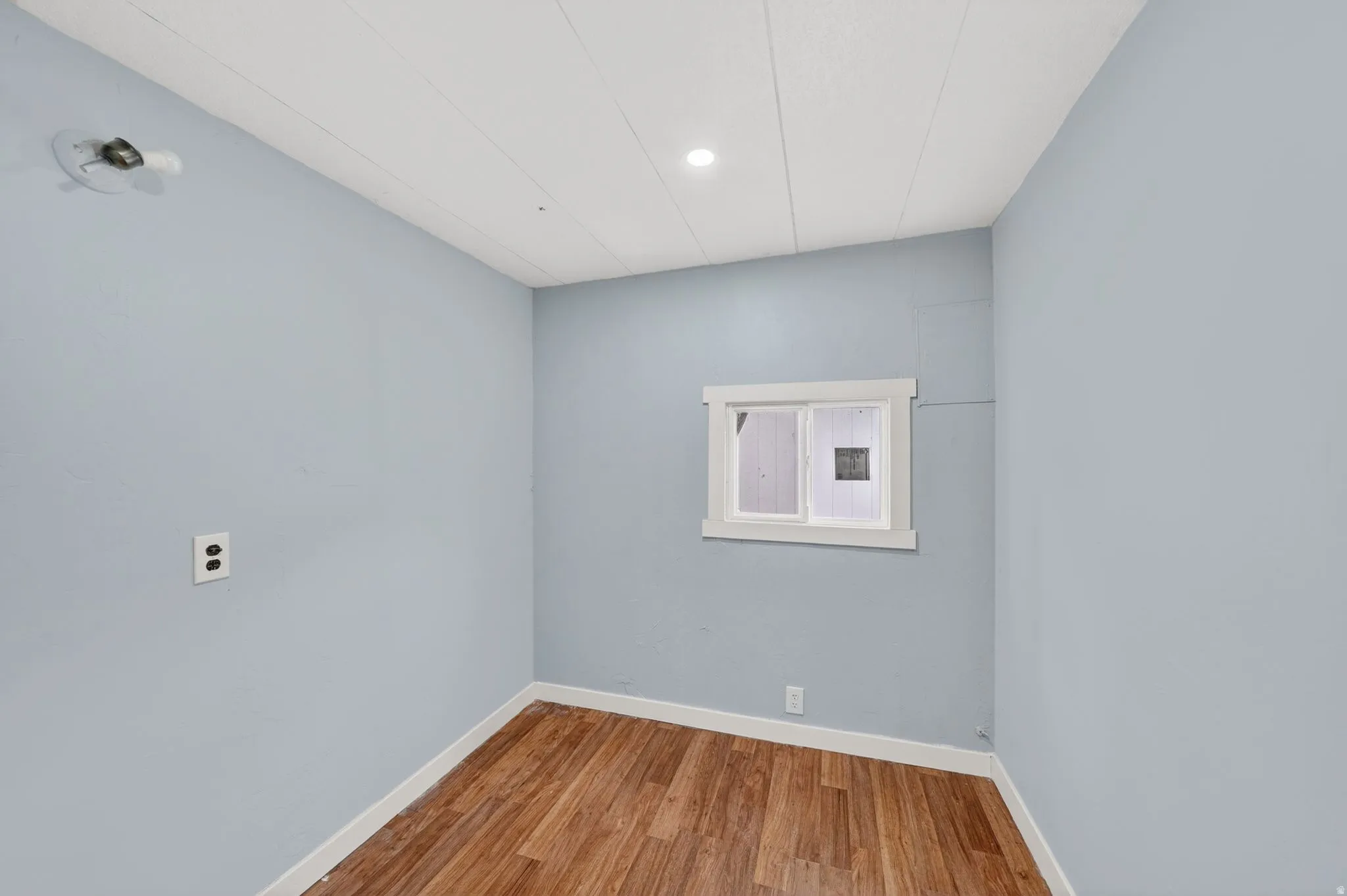 Unfurnished room with baseboards and light wood finished floors