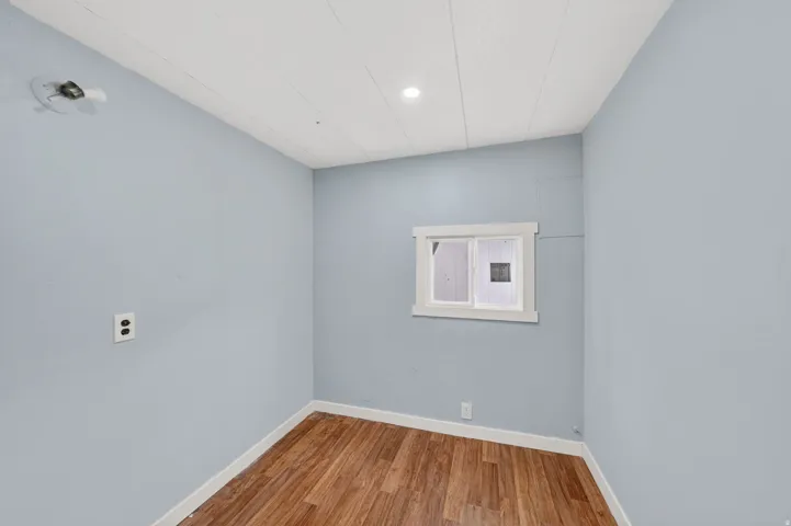 Unfurnished room with baseboards and light wood finished floors
