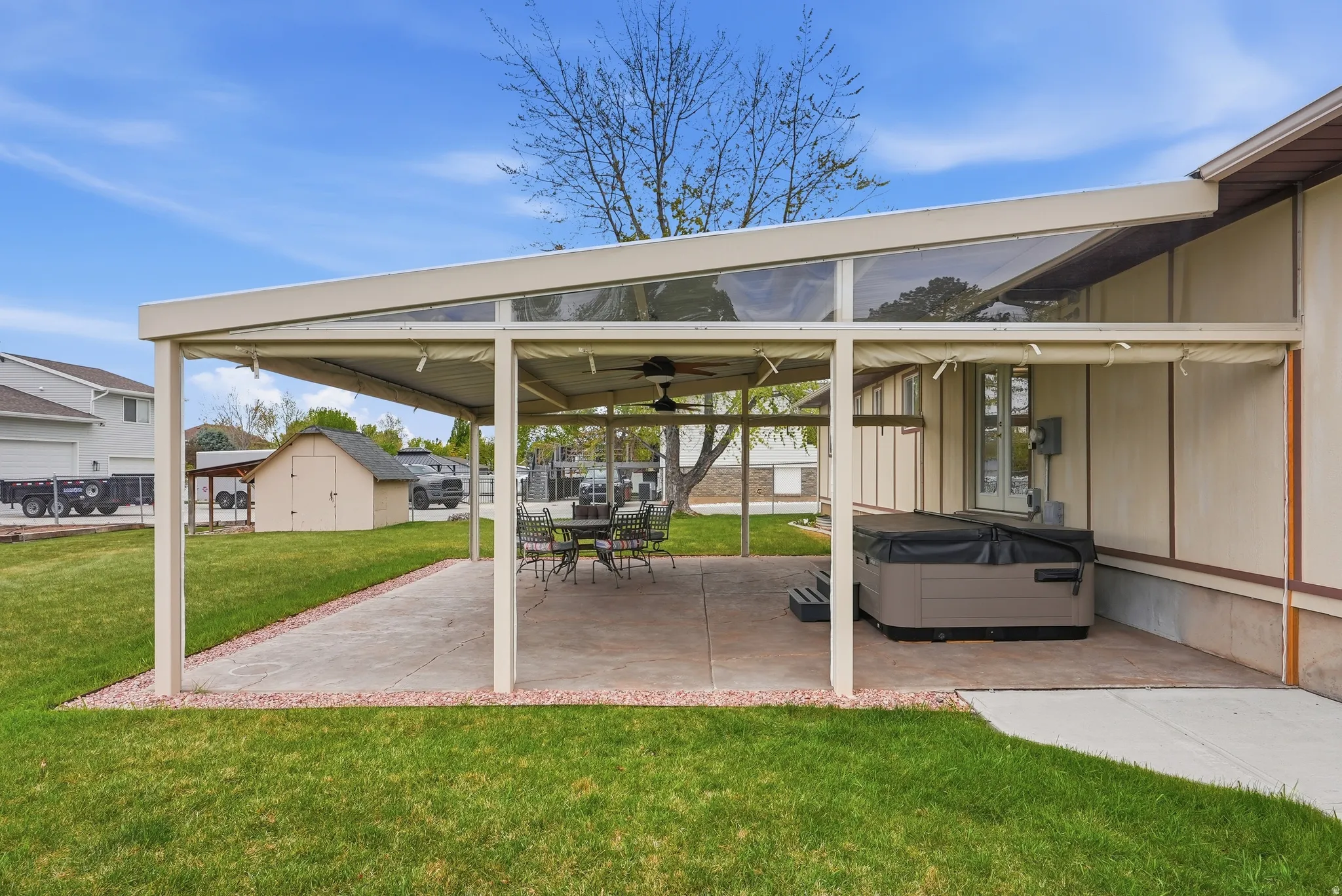 View of patio featuring a ceiling fan, a shed, and outdoor dining area