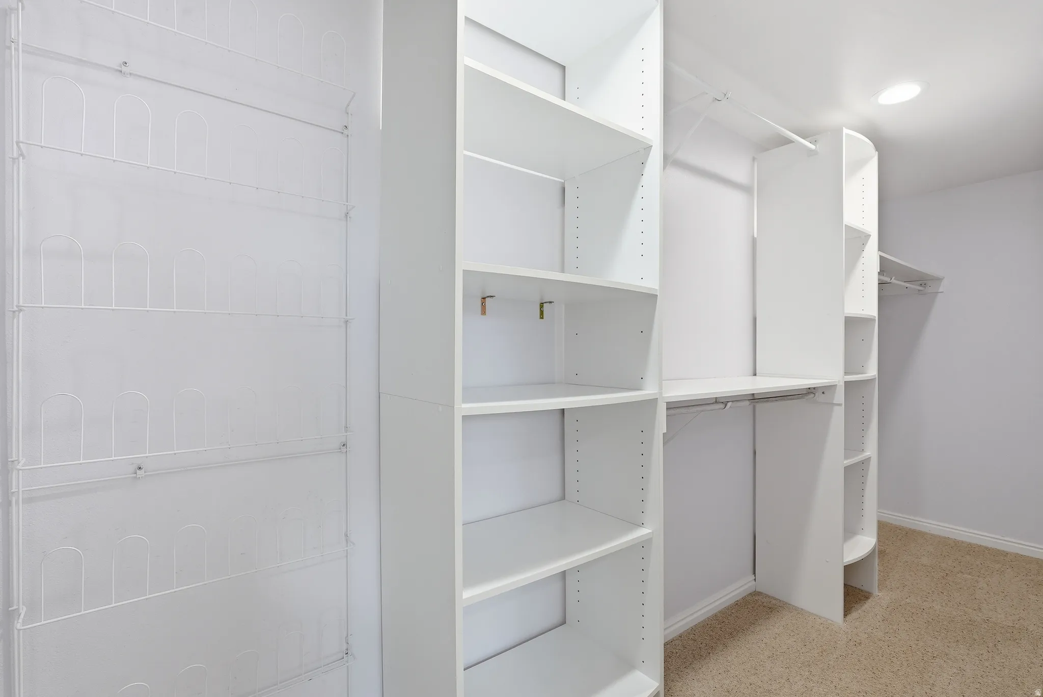 Walk in closet with light carpet