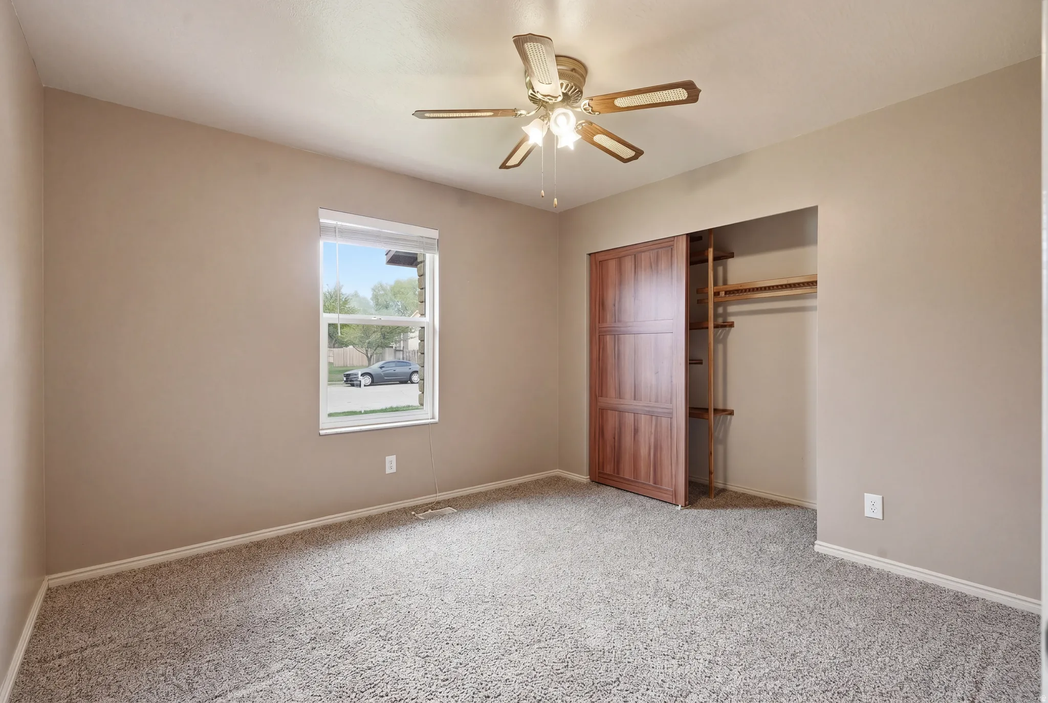 Unfurnished bedroom with a closet, light carpet, and ceiling fan