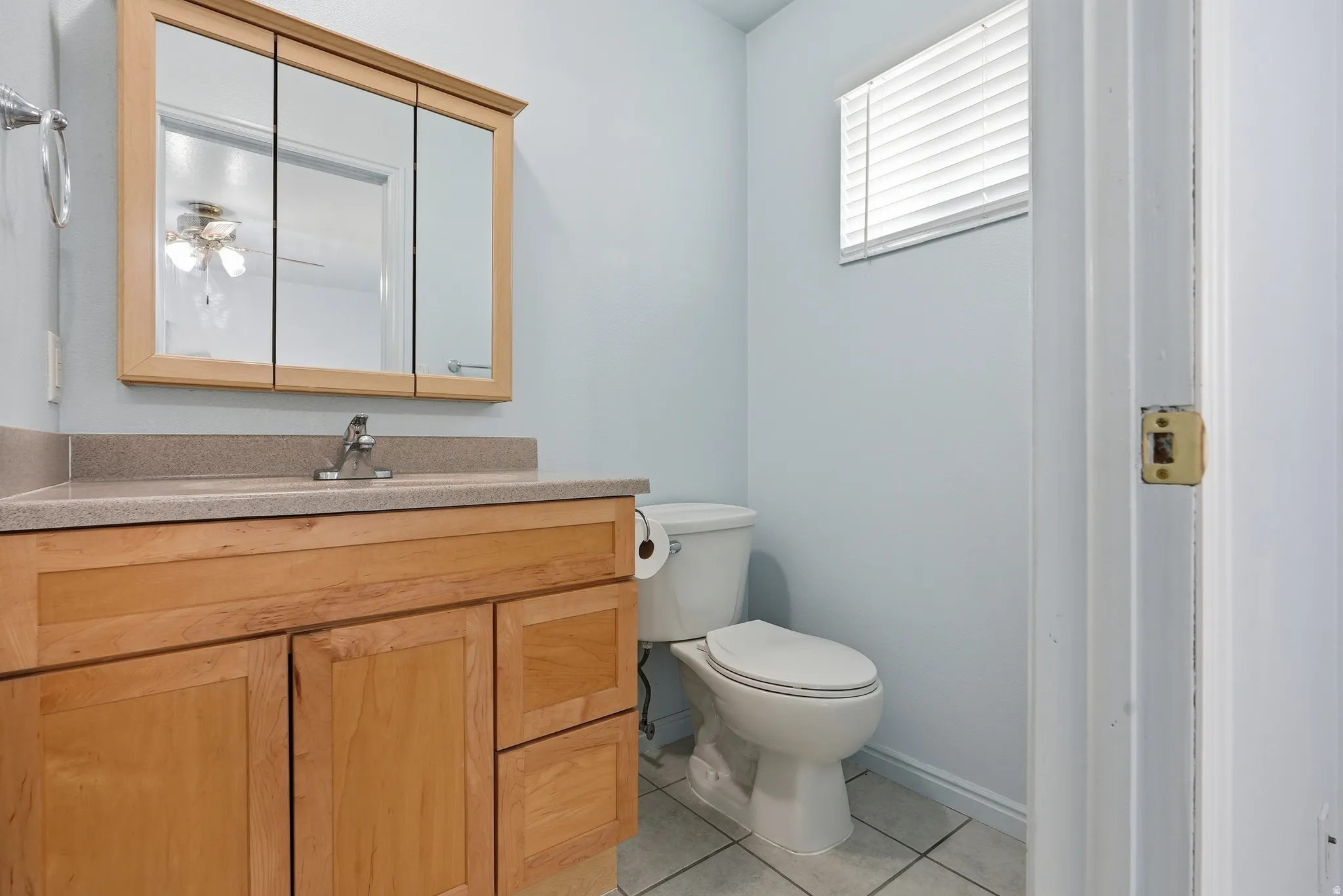 Bathroom with vanity and light tile patterned floors
