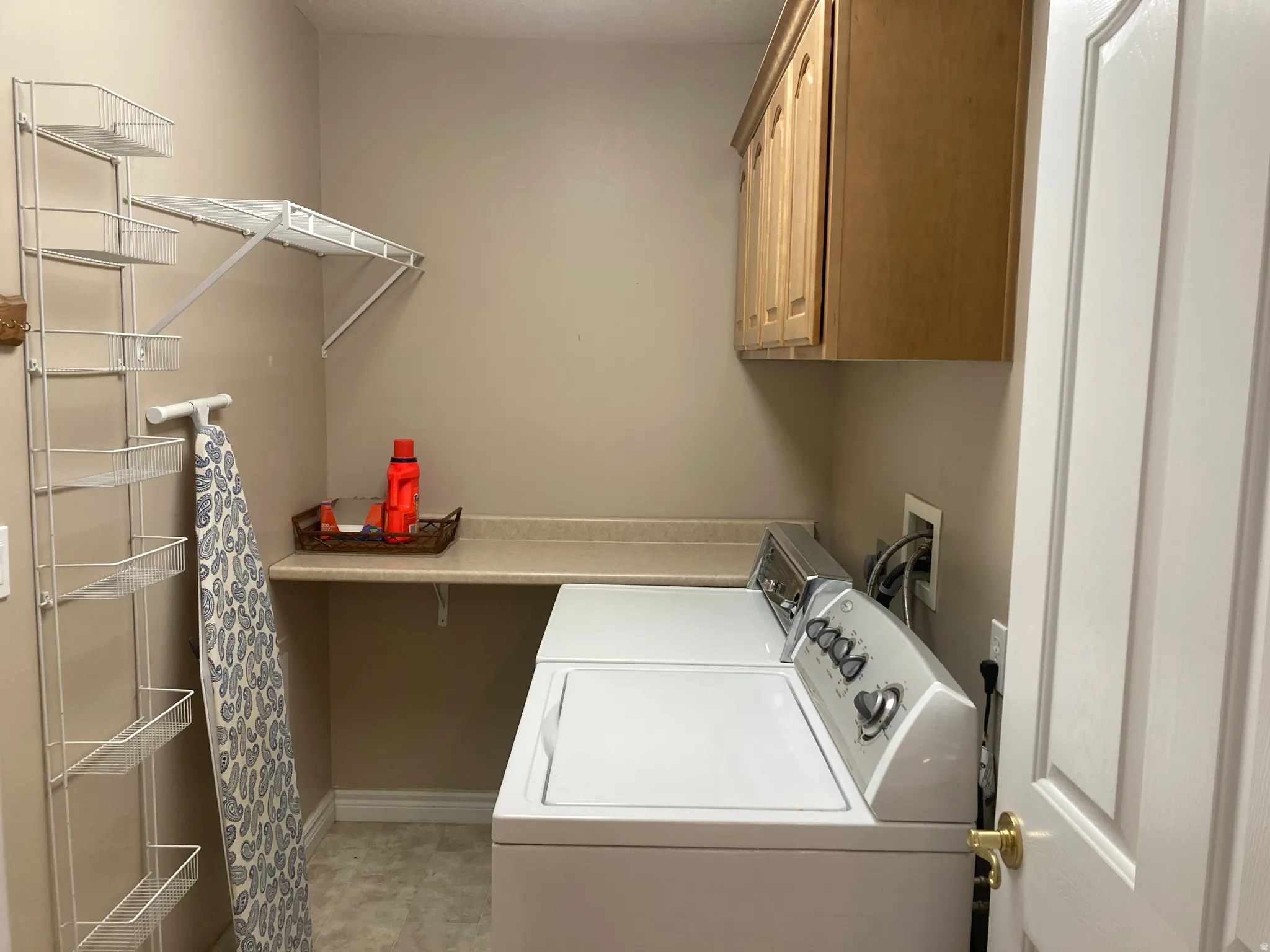 Laundry area featuring cabinet space and independent washer and dryer