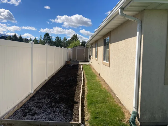 Fenced backyard with a storage unit