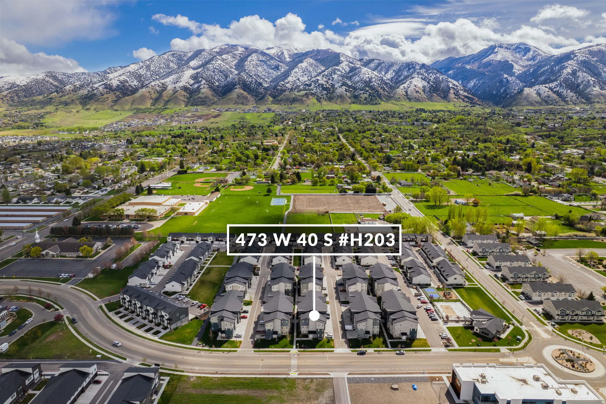 Aerial perspective of suburban area featuring a mountain backdrop
