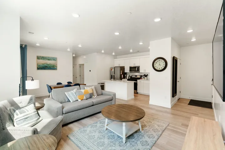 Living room with light wood finished floors and recessed lighting