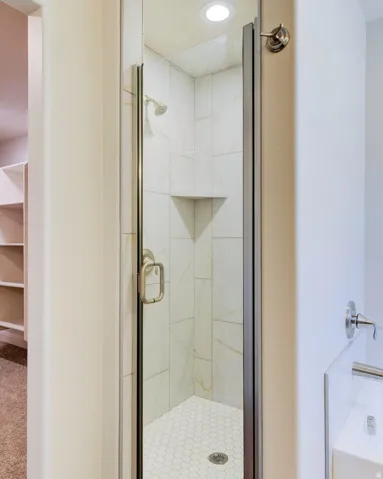 Full bathroom with a stall shower and recessed lighting