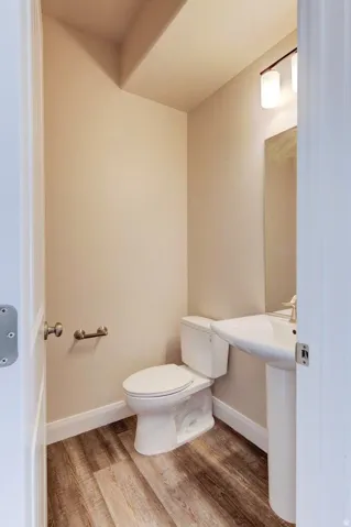 Bathroom with light wood-style floors and toilet