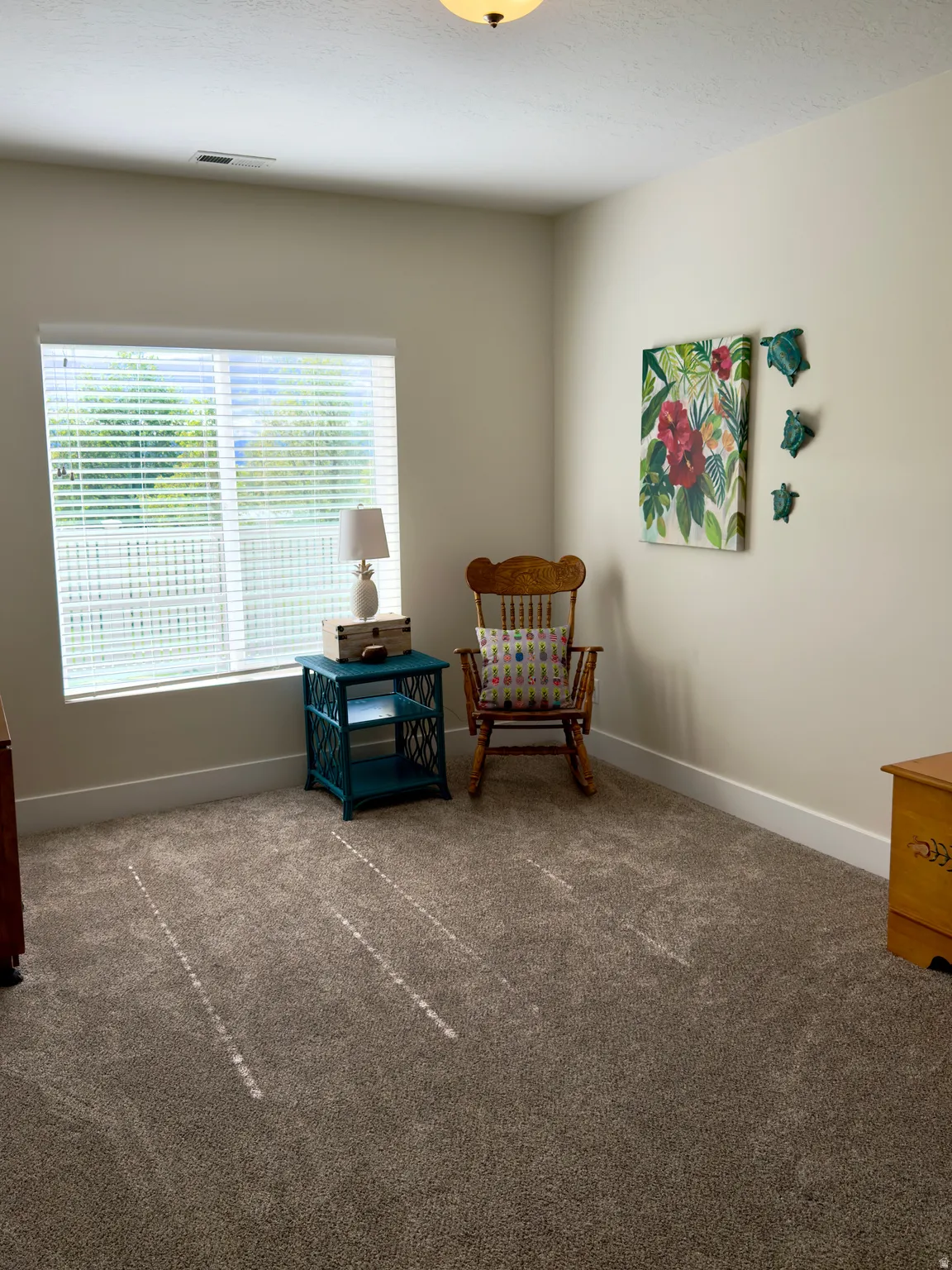Sitting room with carpet and baseboards