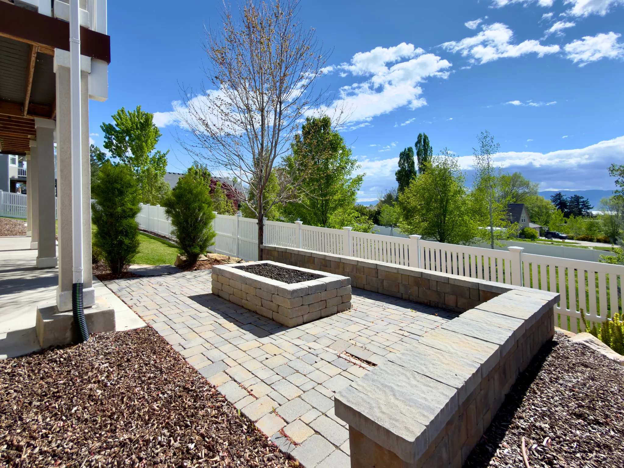 Fenced backyard featuring a patio area and a fire pit