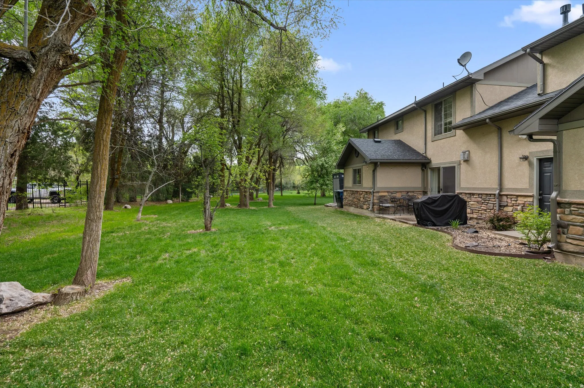 View of grassy yard with a patio