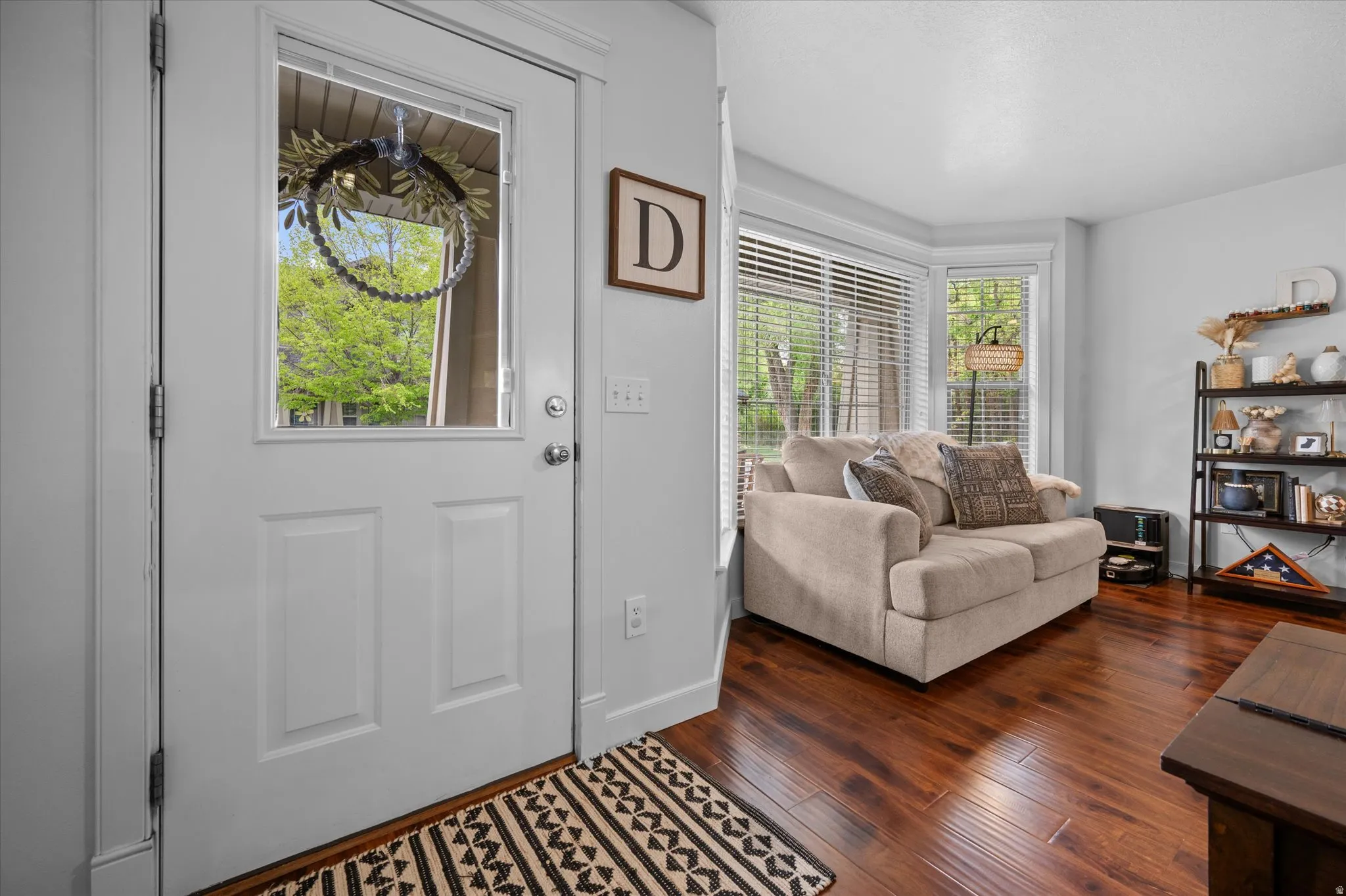Entrance foyer featuring wood-style floors and baseboards