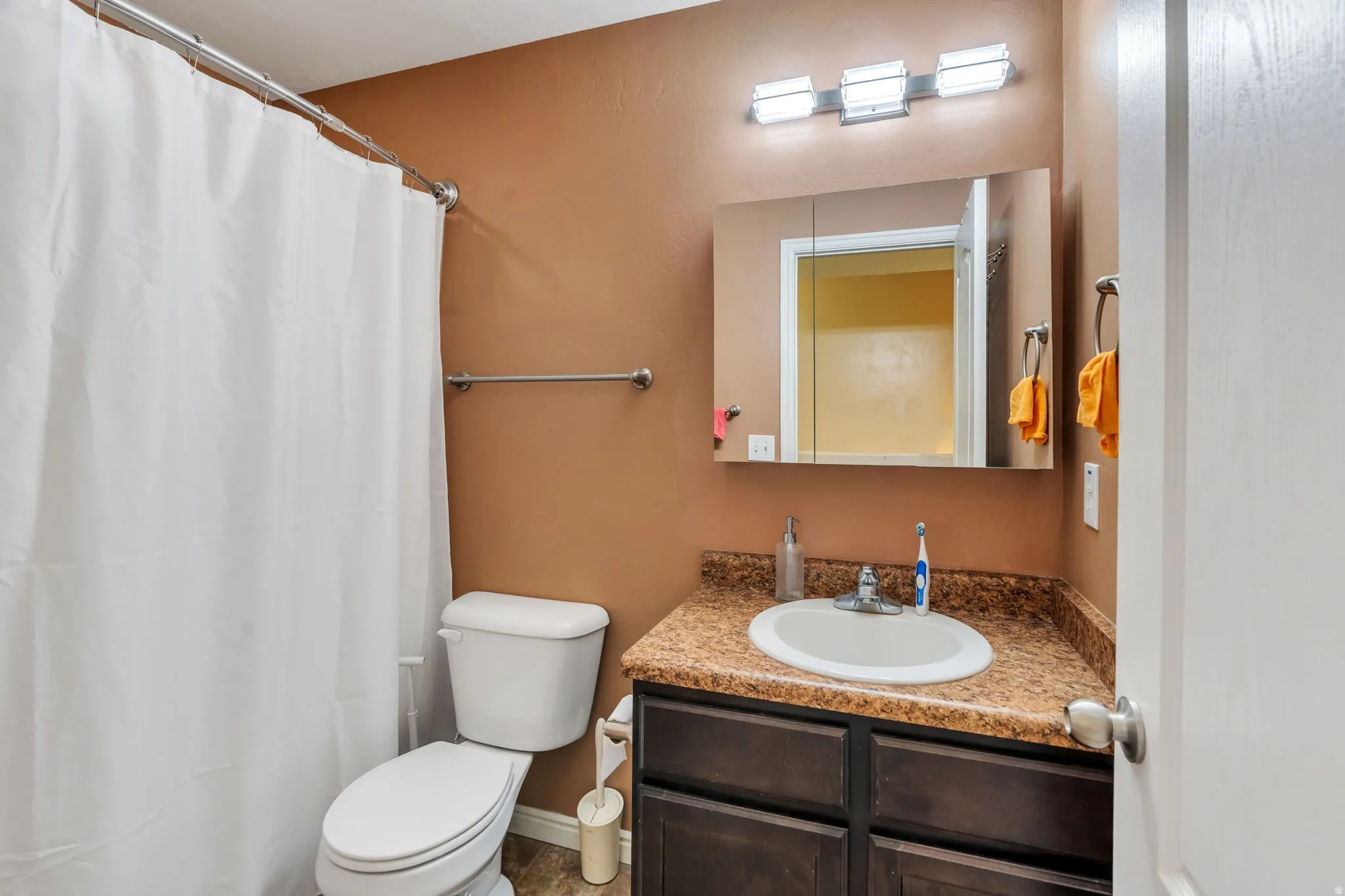 Bathroom with vanity and curtained shower