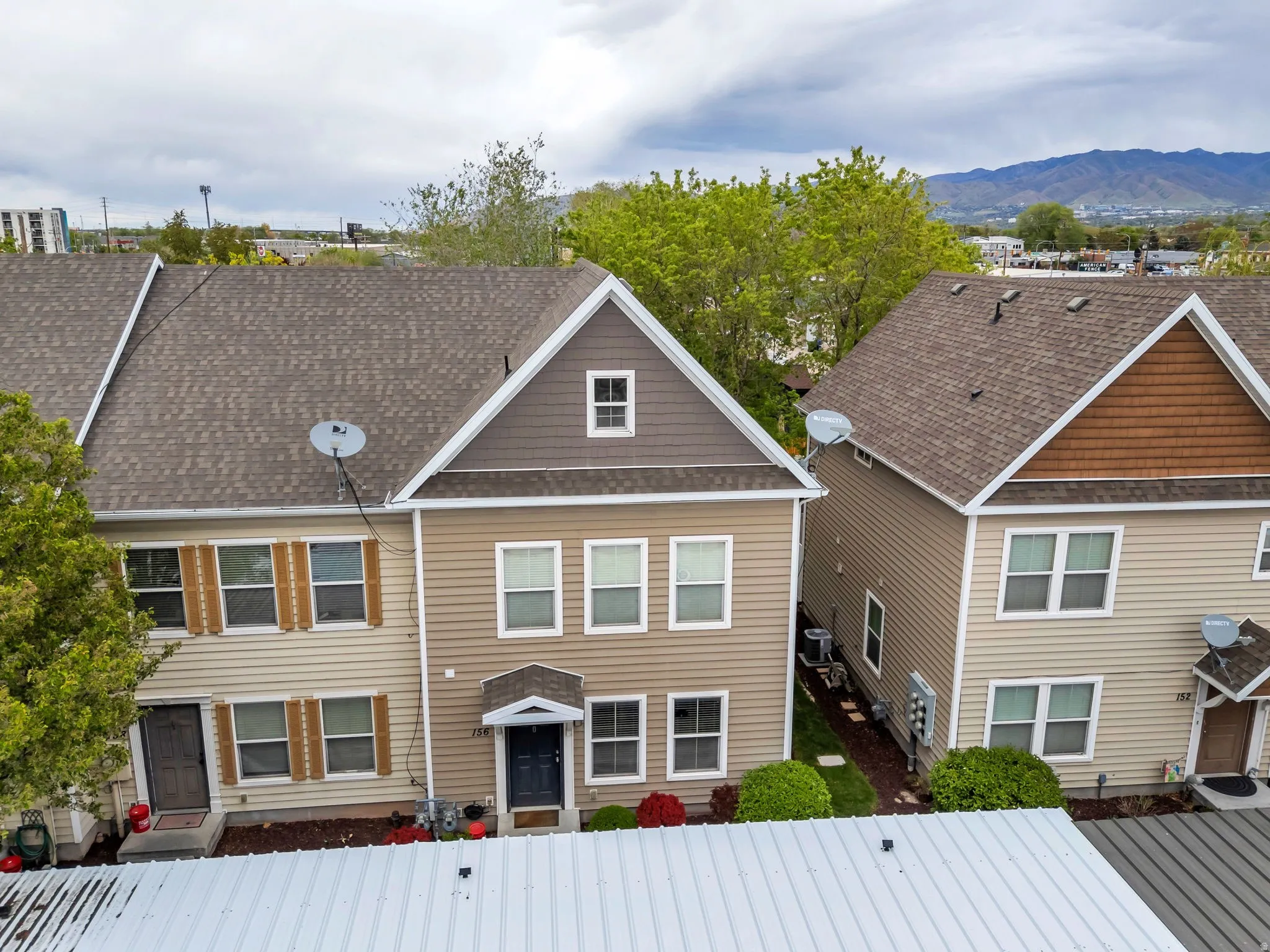 Traditional home with a gate, a fenced front yard, roof with shingles, and a mountain view