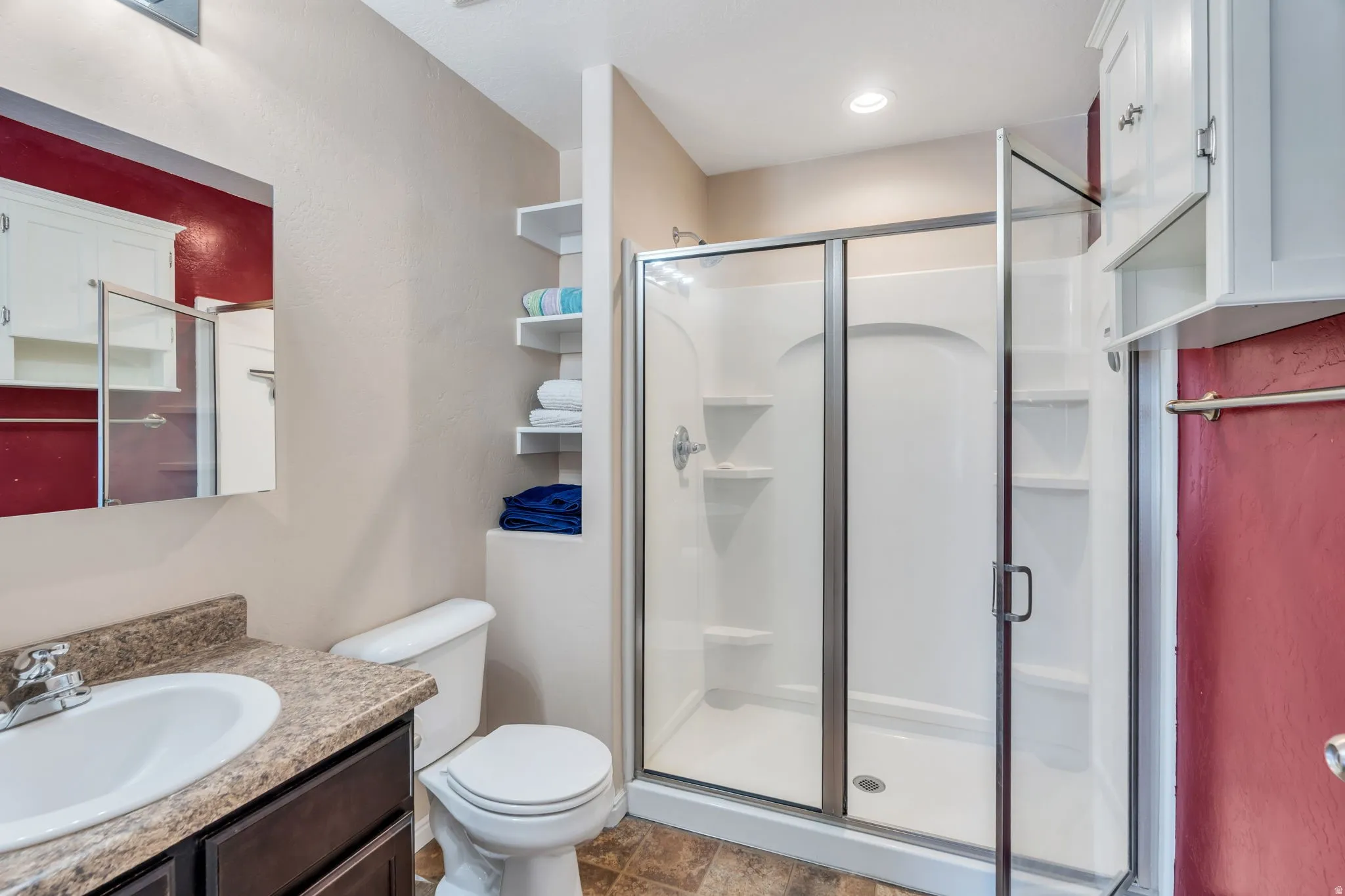 Full bath with vanity and a shower stall