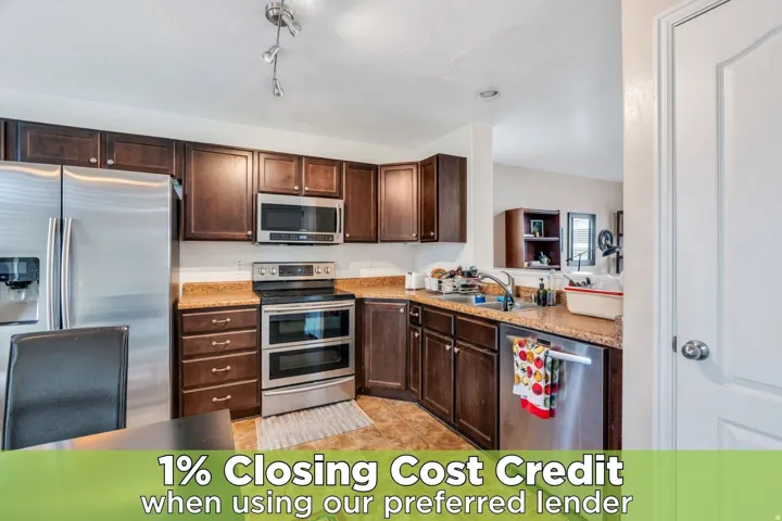 Kitchen featuring stainless steel appliances and dark wood finish cabinetry