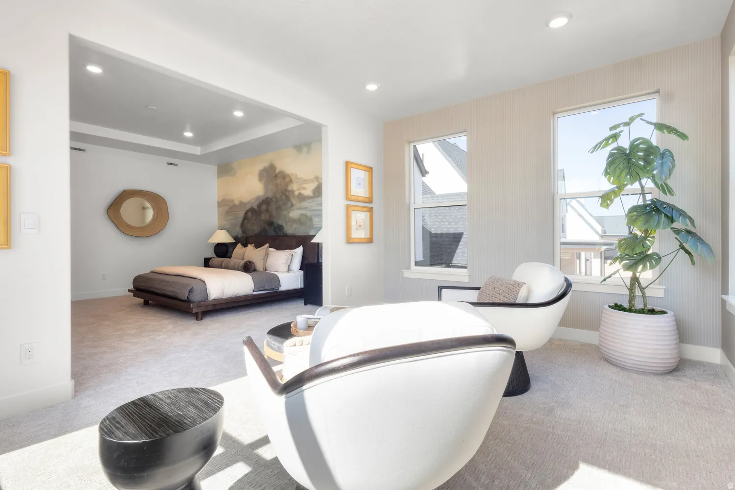 Bedroom with light carpet, recessed lighting, and a raised ceiling
