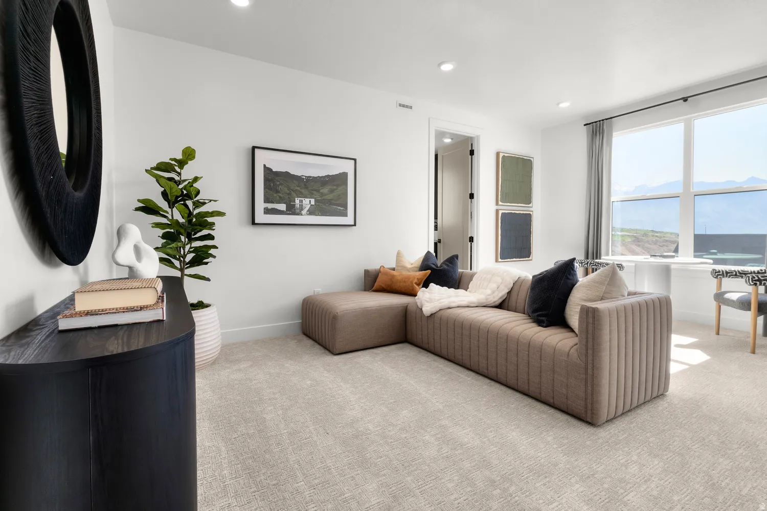 Living room with light carpet, recessed lighting, and a mountain view